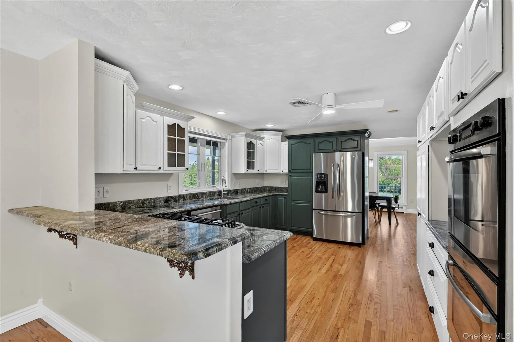 The kitchen offers a warm and functional layout, with generous cabinetry, rich countertops, and an easy flow into the nearby dining space. The kitchen offers a warm and functional layout, with generous cabinetry, rich countertops, and an easy flow into the nearby dining space.