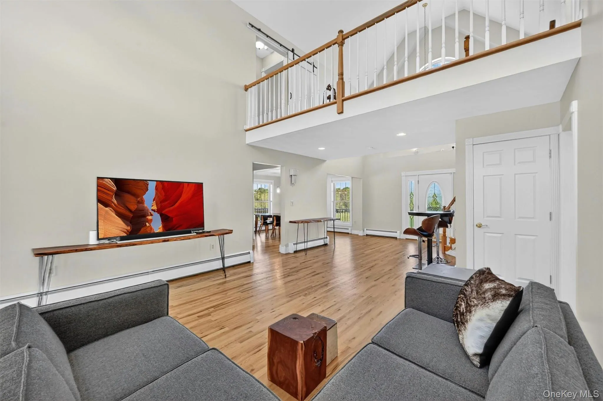 Open sightlines, hardwood floors, and a balcony overlook give the main living area an easy, connected flow. Open sightlines, hardwood floors, and a balcony overlook give the main living area an easy, connected flow.