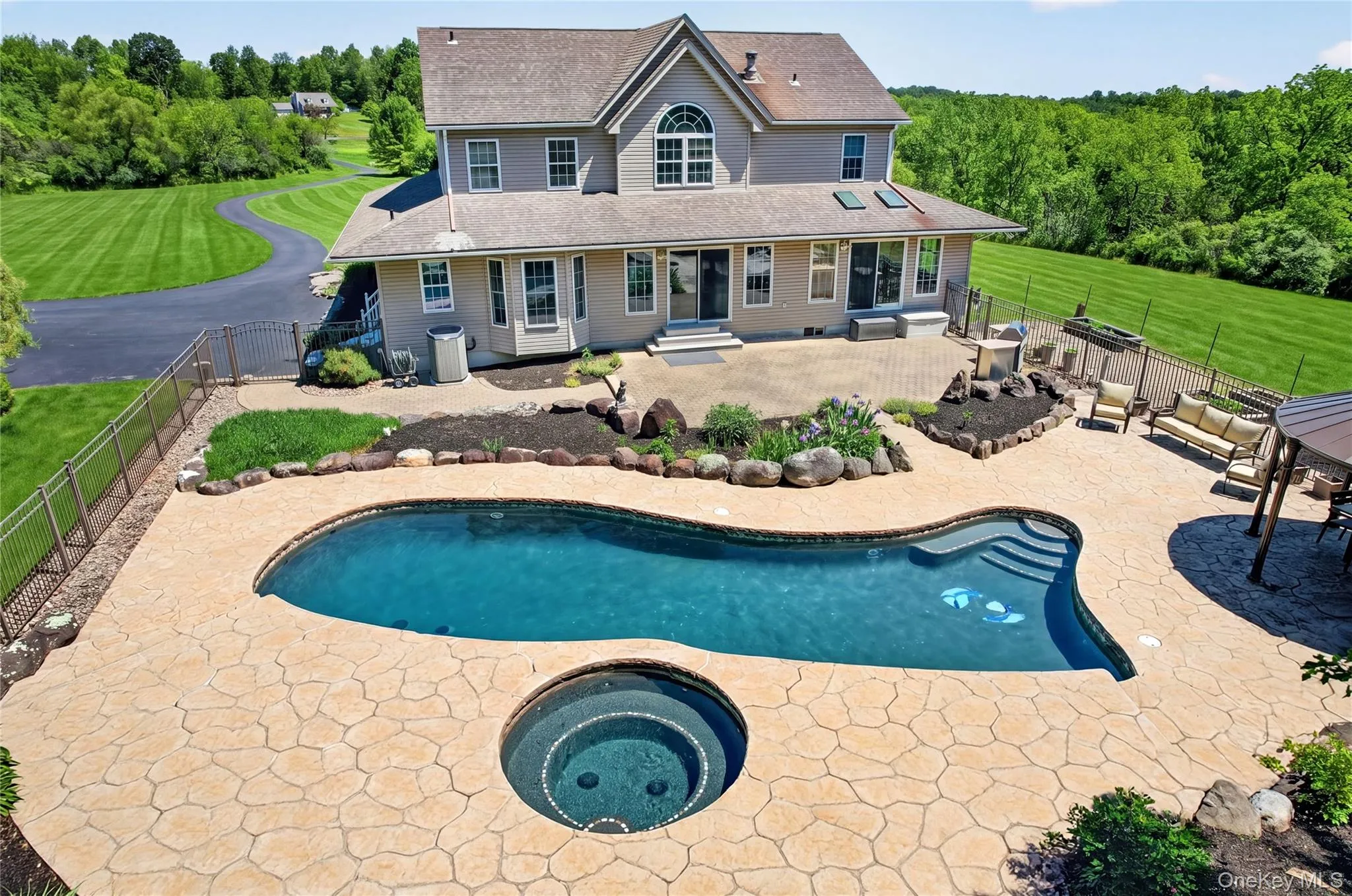 Set on 44+ acres, this remarkable property offers the perfect blend of privacy, recreation, and resort-style living, with space for animal lovers, hunters, nature enthusiasts, and ATV/quadding adventures. Just beyond the home, the backyard features a heated gunite pool, hot tub with waterfalls, gazebo, raised bed gardens, and approximately 5 acres of invisible fencing. Set on 44+ acres, this remarkable property offers the perfect blend of privacy, recreation, and resort-style living, with space for animal lovers, hunters, nature enthusiasts, and ATV/quadding adventures. Just beyond the home, the backyard features a heated gunite pool, hot tub with waterfalls, gazebo, raised bed gardens, and approximately 5 acres of invisible fencing.