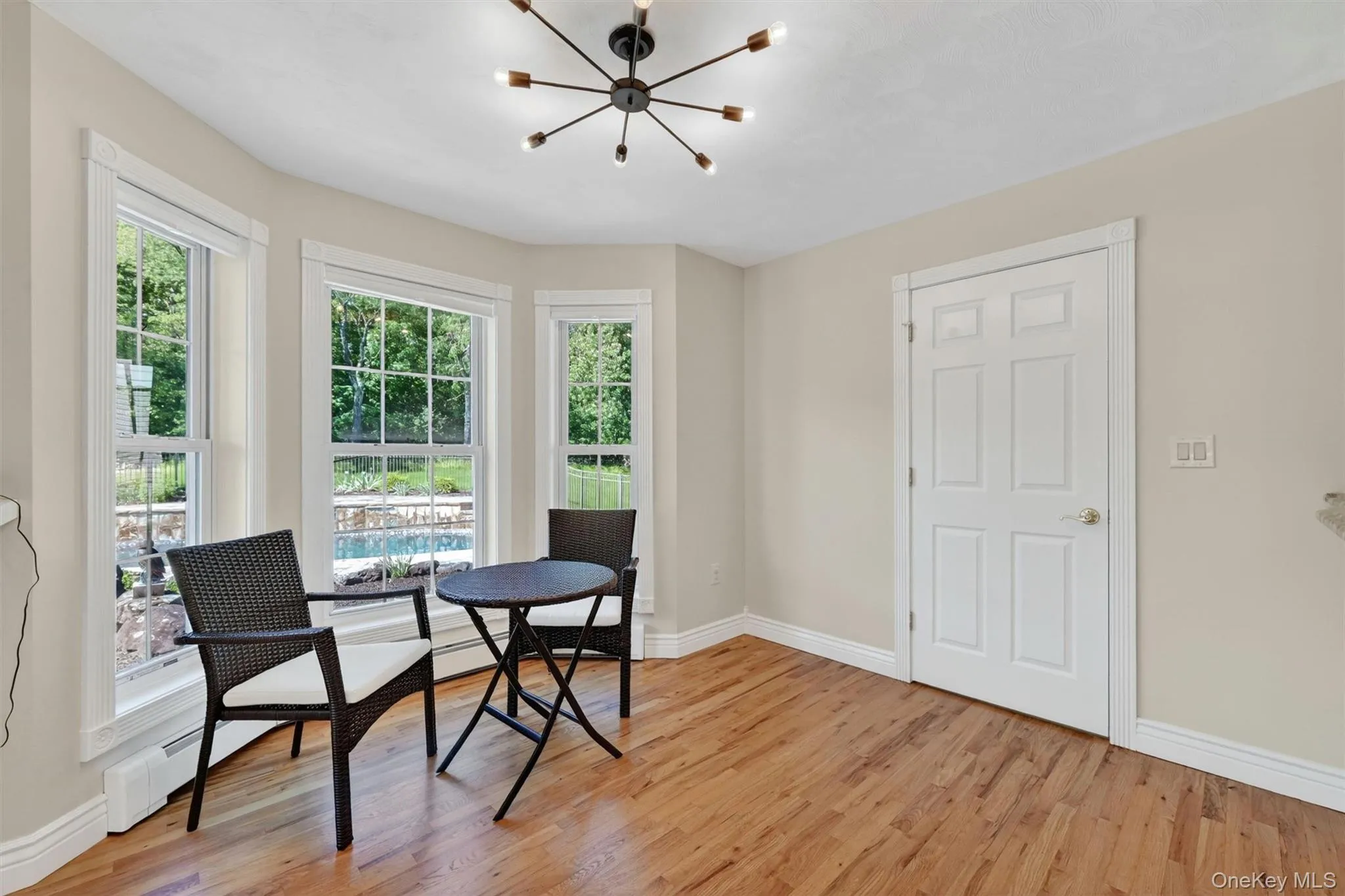 A cozy dining nook overlooks the pool and garden area, creating a lovely spot for morning coffee, casual meals, or quiet conversation. A cozy dining nook overlooks the pool and garden area, creating a lovely spot for morning coffee, casual meals, or quiet conversation.