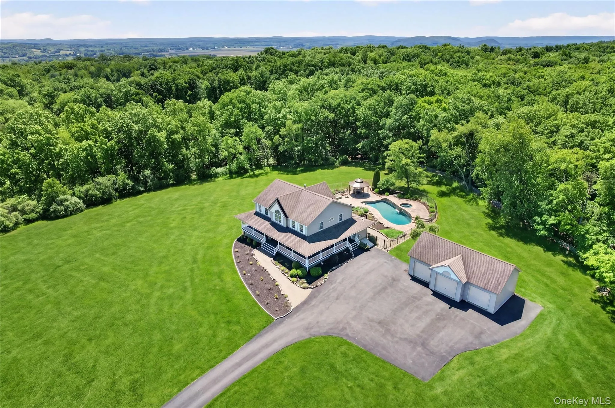 A sweeping aerial view captures the lifestyle this property offers, with room to breathe, open lawns, a 3-car detached garage, and a backyard designed for relaxing and entertaining. A sweeping aerial view captures the lifestyle this property offers, with room to breathe, open lawns, a 3-car detached garage, and a backyard designed for relaxing and entertaining.