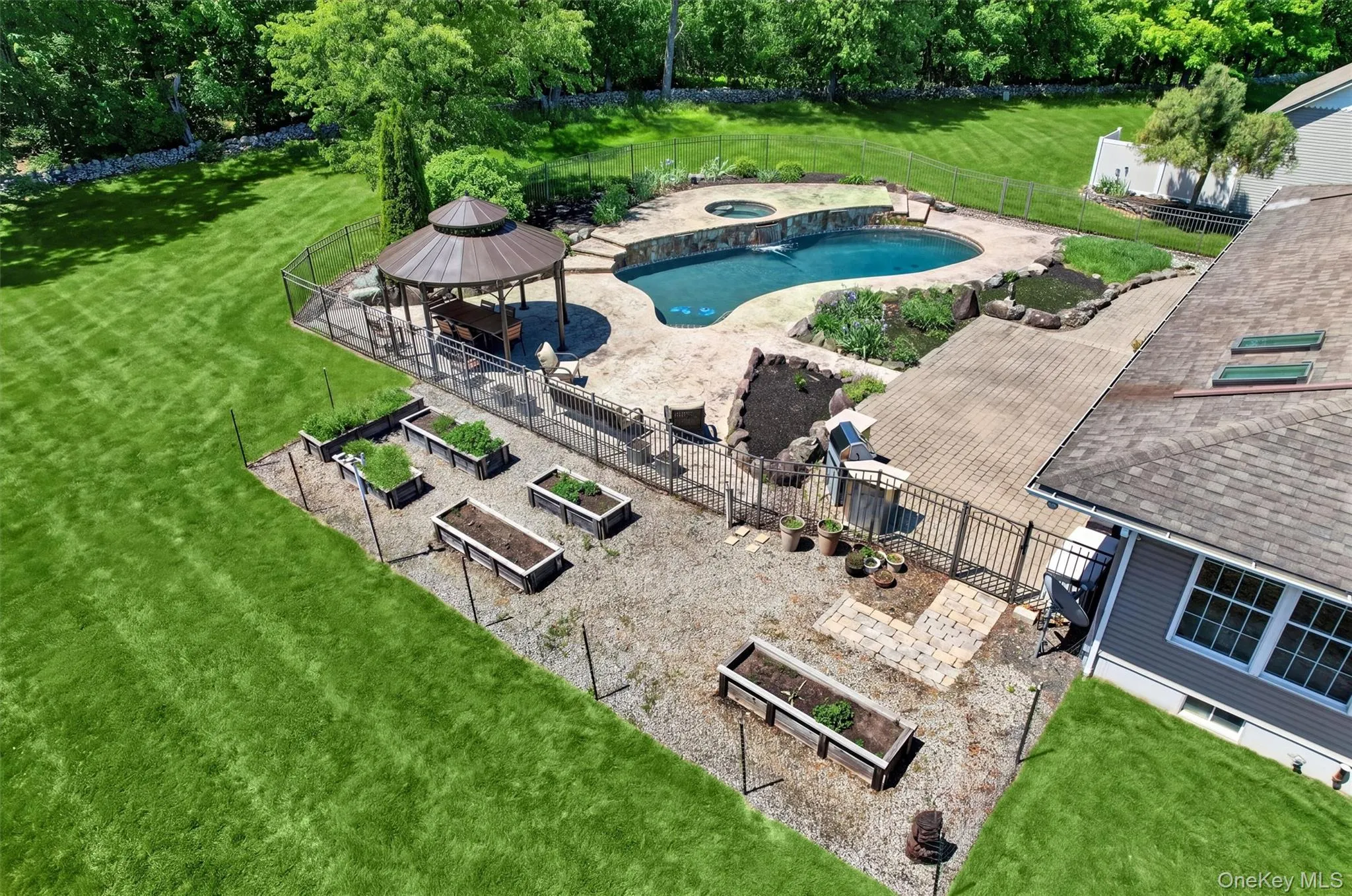 From above, the backyard feels like its own private retreat, with space for gardening, relaxing by the pool, and enjoying long summer days outdoors. From above, the backyard feels like its own private retreat, with space for gardening, relaxing by the pool, and enjoying long summer days outdoors.