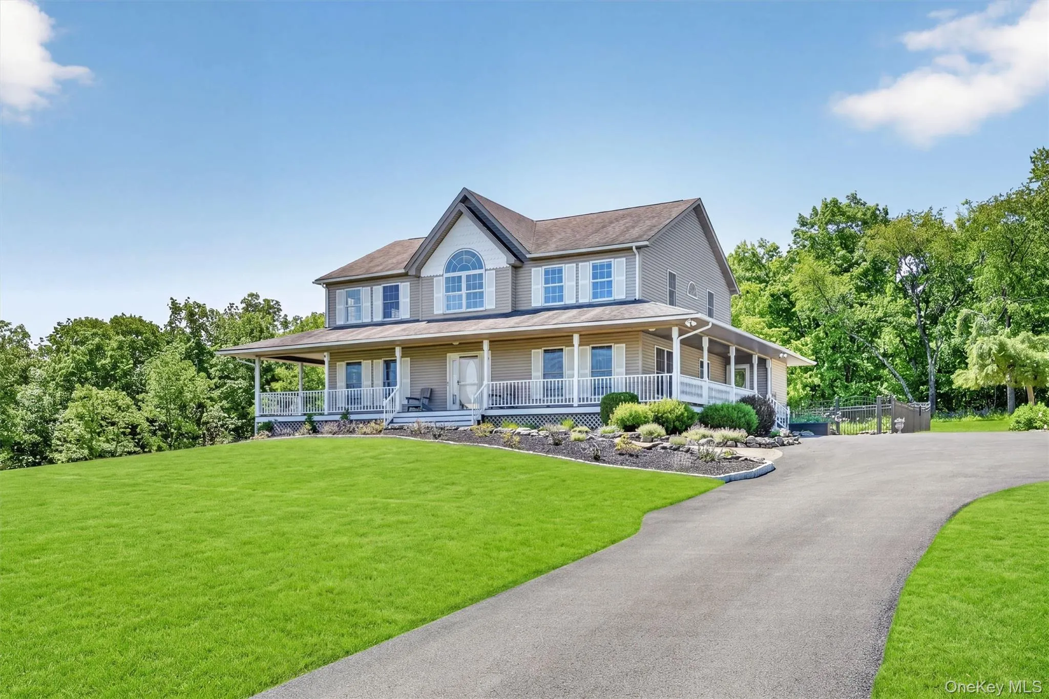 The home sits beautifully against the landscape, with its wraparound porch, manicured grounds, and classic exterior offering timeless curb appeal. The home sits beautifully against the landscape, with its wraparound porch, manicured grounds, and classic exterior offering timeless curb appeal.