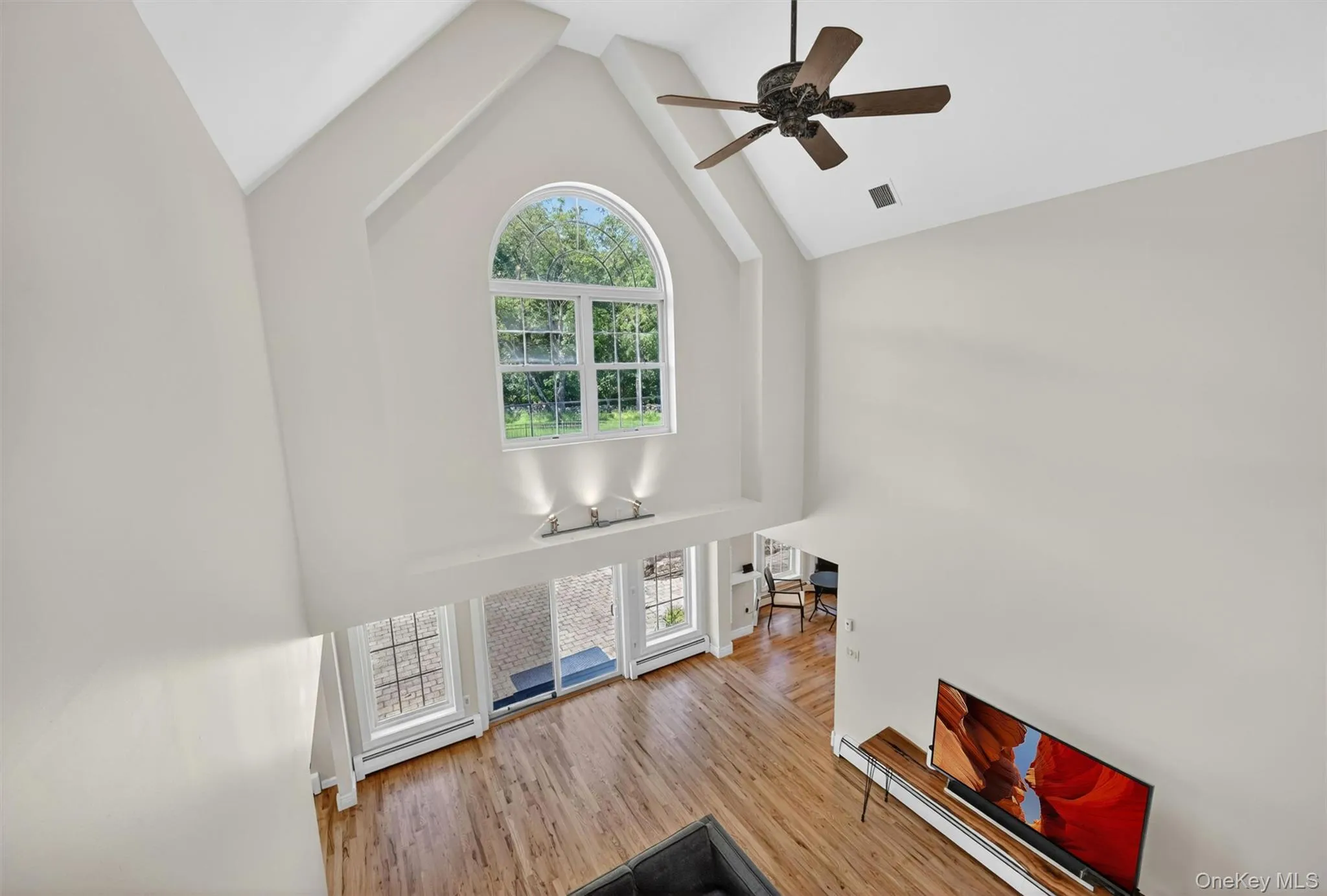 From the 2nd floor landing, you can see how the living room feels grand and open, with soaring ceilings, tall windows, and a dramatic sense of light and space. From the 2nd floor landing, you can see how the living room feels grand and open, with soaring ceilings, tall windows, and a dramatic sense of light and space.