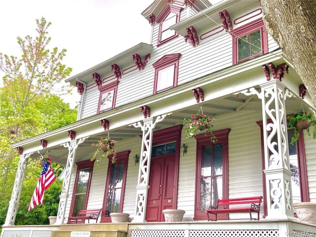 Italianate property featuring covered porch Italianate property featuring covered porch
