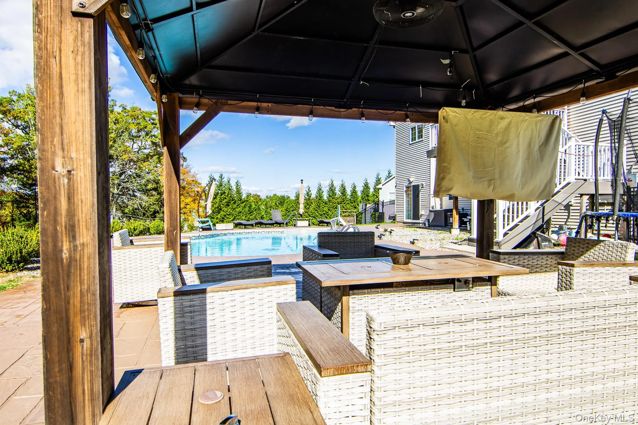 Deck featuring a gazebo, a patio, and an outdoor pool Deck featuring a gazebo, a patio, and an outdoor pool
