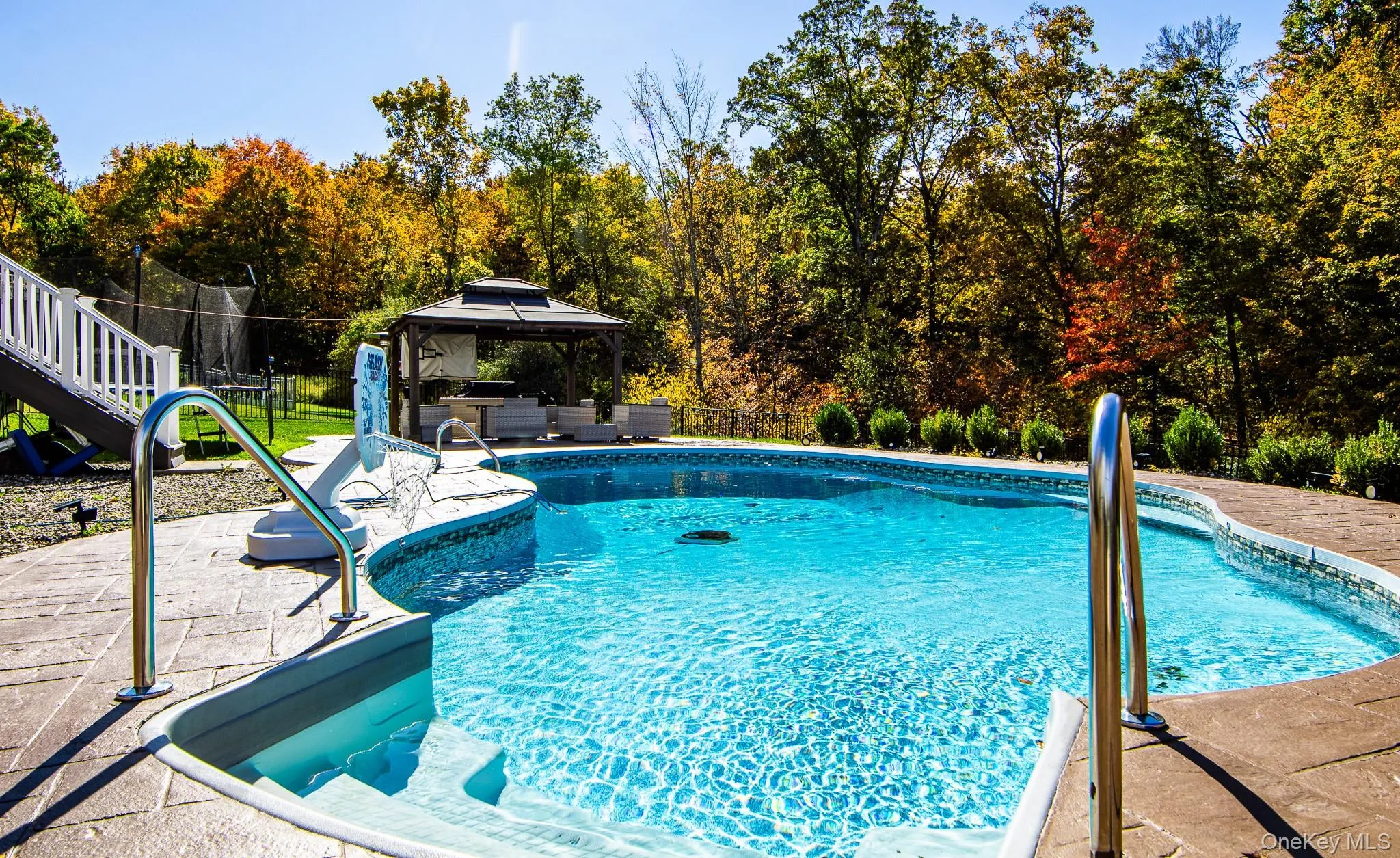 Outdoor pool with a gazebo, an outdoor living space, a patio area, and a fenced backyard Outdoor pool with a gazebo, an outdoor living space, a patio area, and a fenced backyard