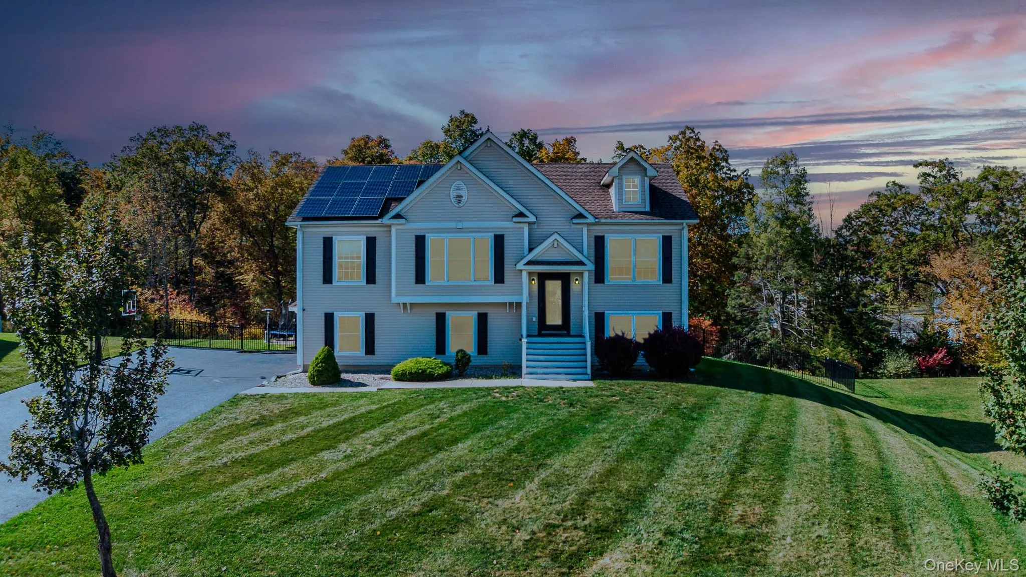 Bi-level home with solar panels and driveway Bi-level home with solar panels and driveway