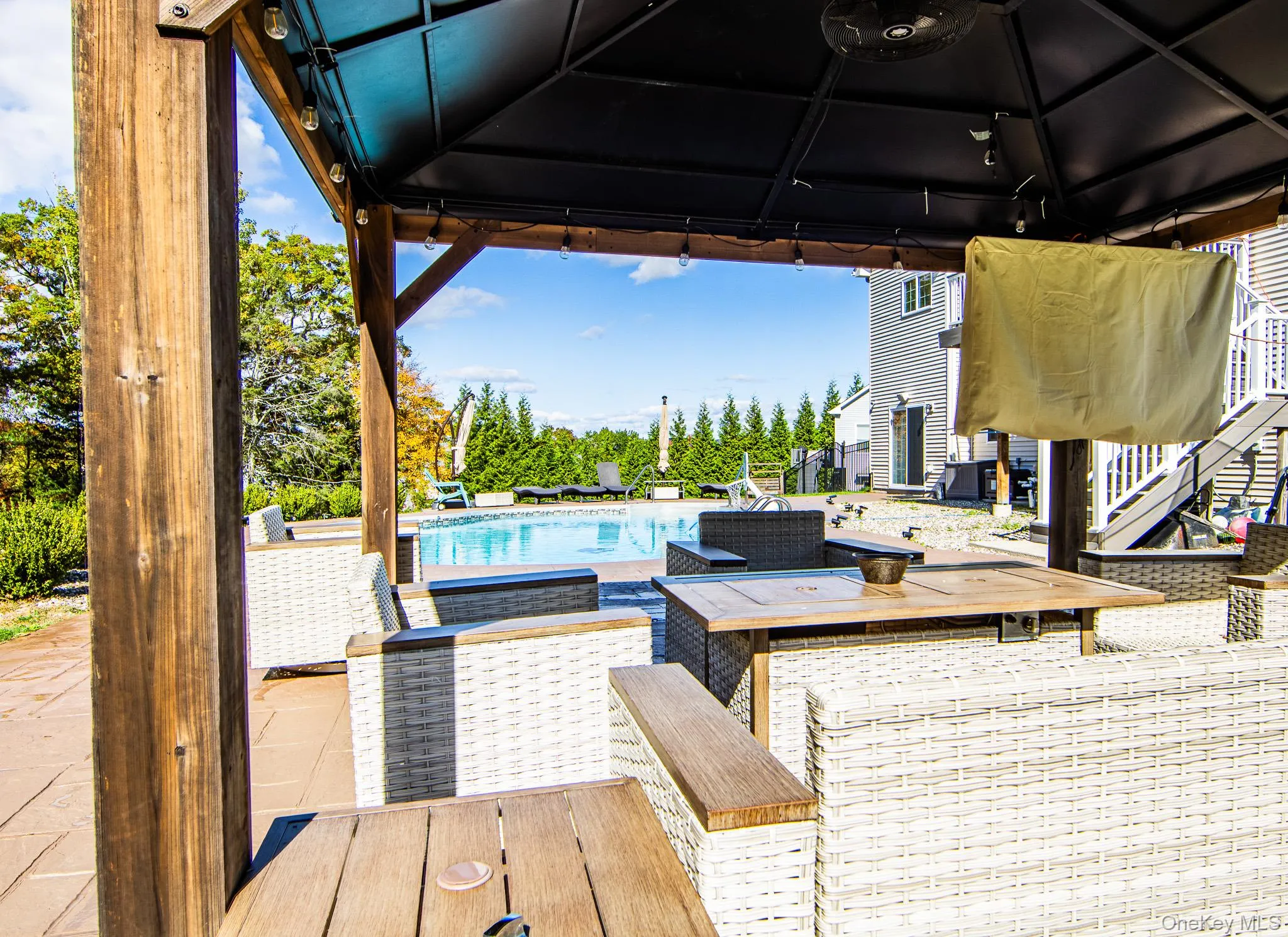 Deck with a gazebo, a patio, an outdoor pool, and outdoor dining area Deck with a gazebo, a patio, an outdoor pool, and outdoor dining area