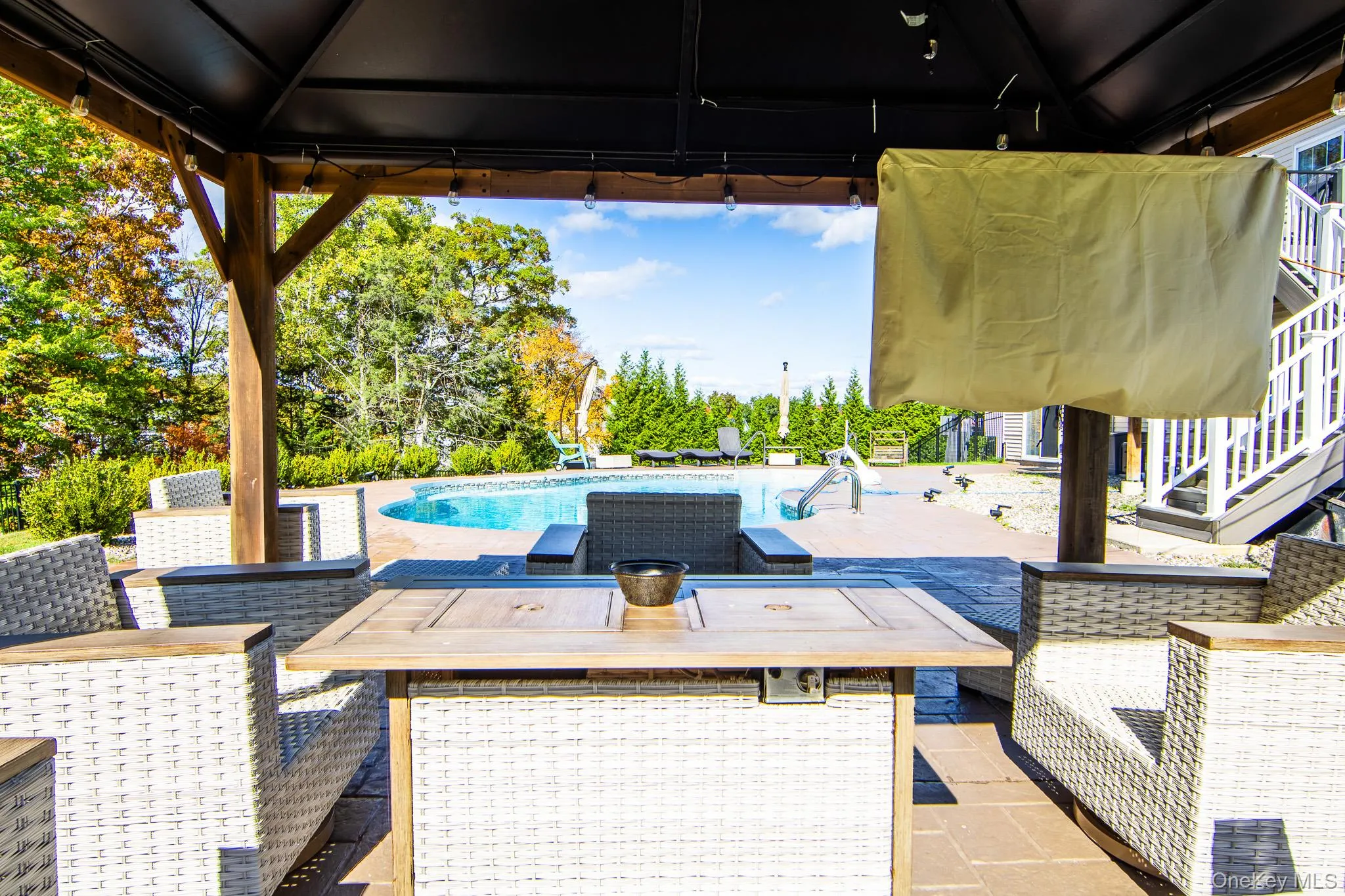 View of patio / terrace with an outdoor pool, stairway, and outdoor lounge area View of patio / terrace with an outdoor pool, stairway, and outdoor lounge area