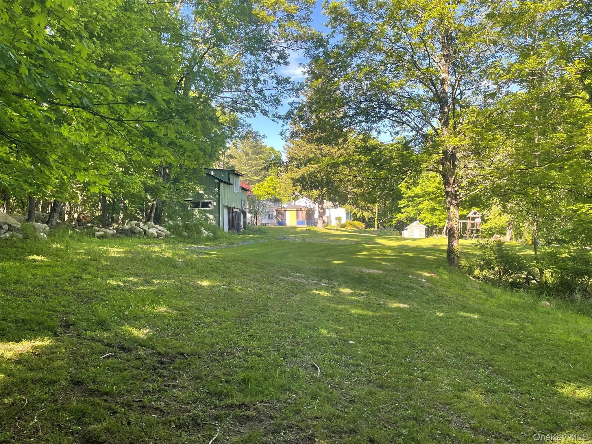 View of grassy yard featuring an outdoor structure View of grassy yard featuring an outdoor structure