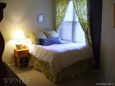 Second bedroom hosts full sized bed and closet. Floor has wall to wall carpeting. Second bedroom hosts full sized bed and closet. Floor has wall to wall carpeting.