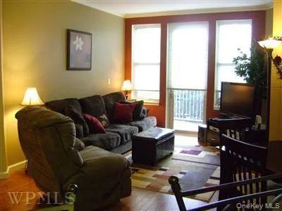 Bright and sunny! Living room has appealing custom paint, high ceilings, wood floors and door to private patio. Bright and sunny! Living room has appealing custom paint, high ceilings, wood floors and door to private patio.