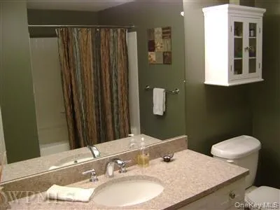 Another view of the master bathroom shows bathtub with shower. Another view of the master bathroom shows bathtub with shower.