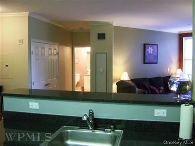 View from kitchen towards the living room and hall bathroom. Doors on the left are to the private laundry with full size washer and dryer. View from kitchen towards the living room and hall bathroom. Doors on the left are to the private laundry with full size washer and dryer.