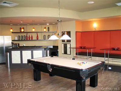 Another view of the club room shows the billiards table and the catering kitchen. Another view of the club room shows the billiards table and the catering kitchen.