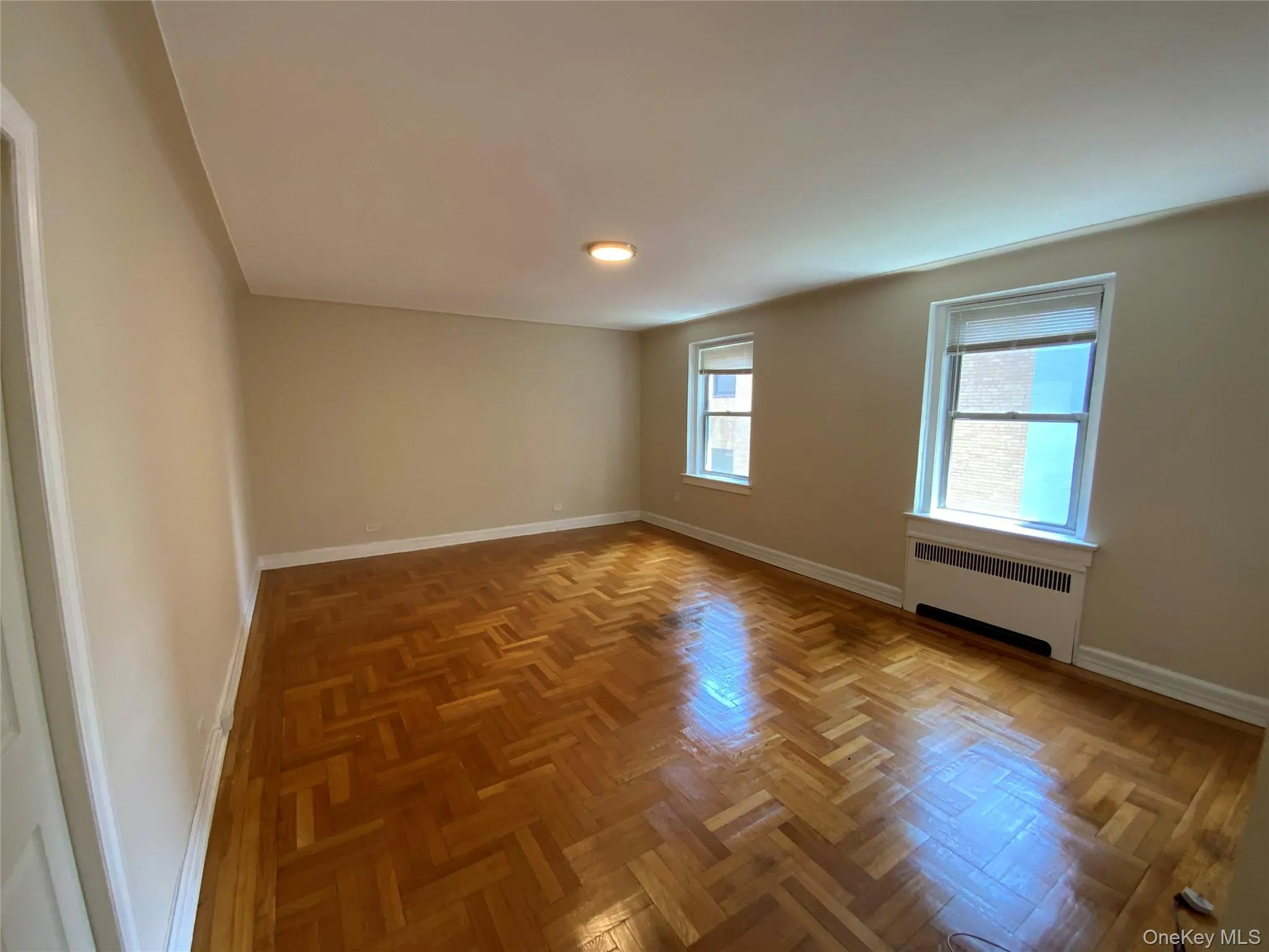 Unfurnished room featuring baseboards and radiator Unfurnished room featuring baseboards and radiator