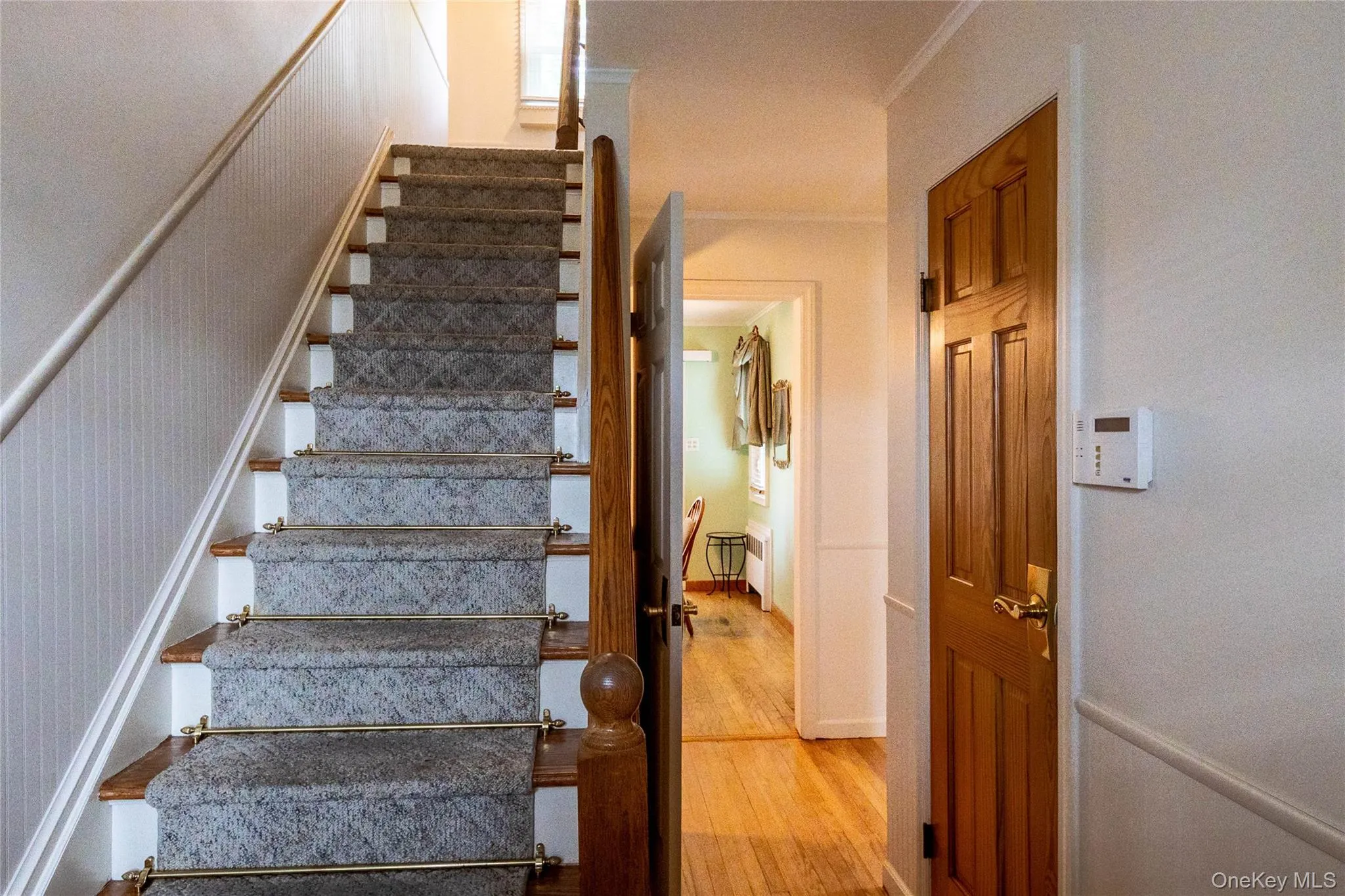Hardwood staircase with carpet runner and brass stair rods Hardwood staircase with carpet runner and brass stair rods