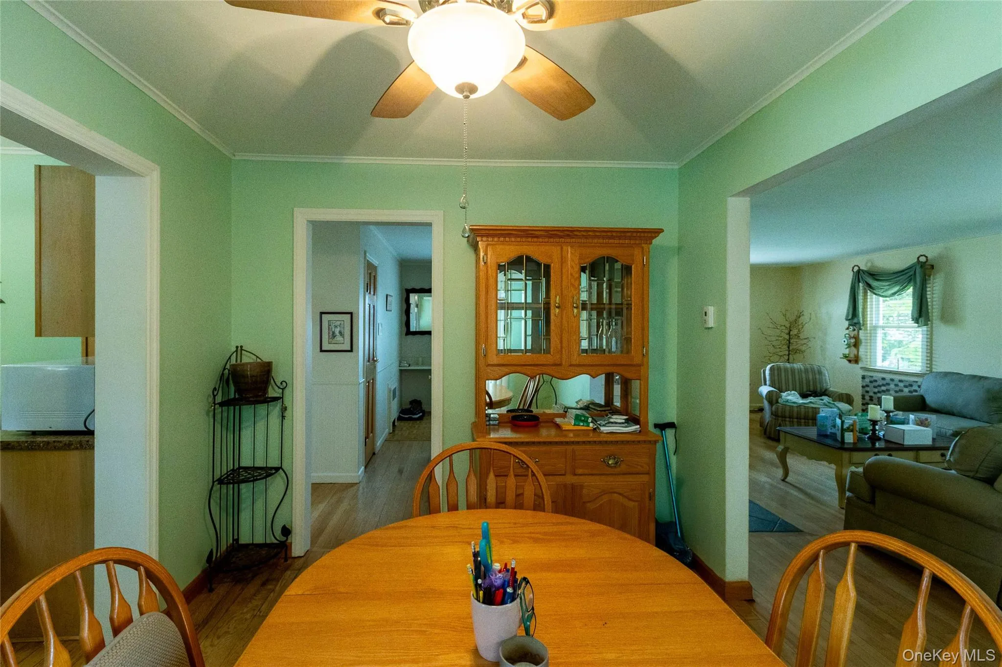 Dining area featuring wood-finish flooring and a ceiling fan with integrated lighting Dining area featuring wood-finish flooring and a ceiling fan with integrated lighting