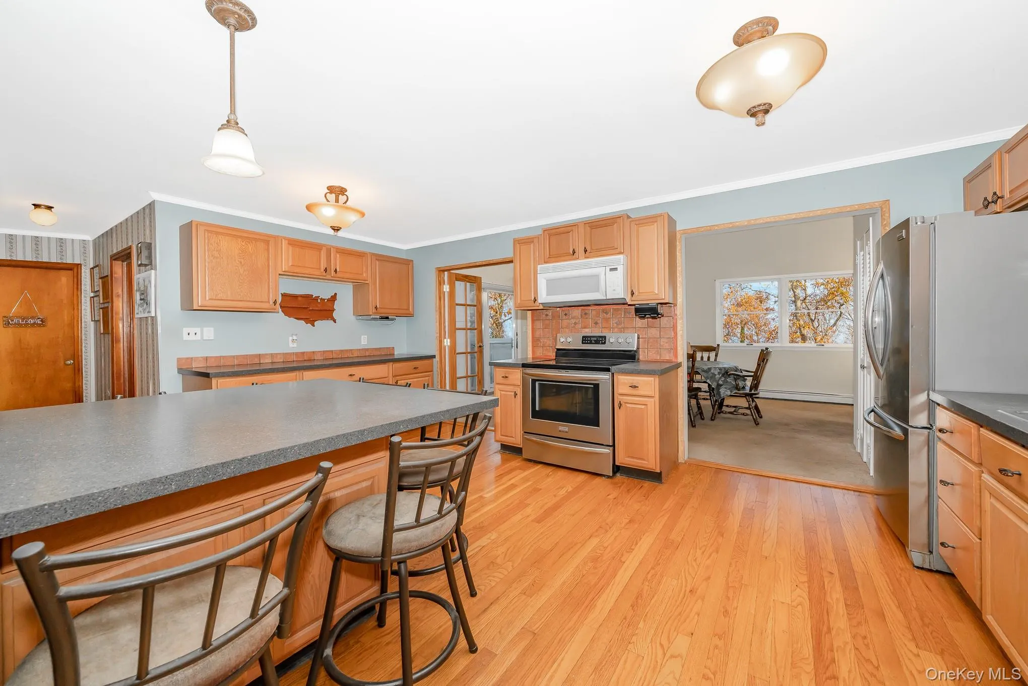 Eat-in kitchen with peninsula seating and ample cabinetry Eat-in kitchen with peninsula seating and ample cabinetry