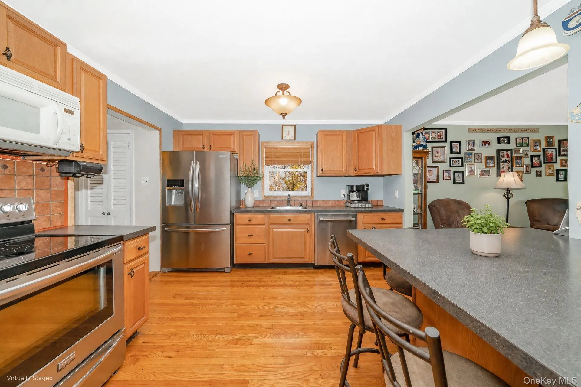 Kitchen flows from here into the adjacent pantry and dining area (Staged with virtual decor) Kitchen flows from here into the adjacent pantry and dining area (Staged with virtual decor)
