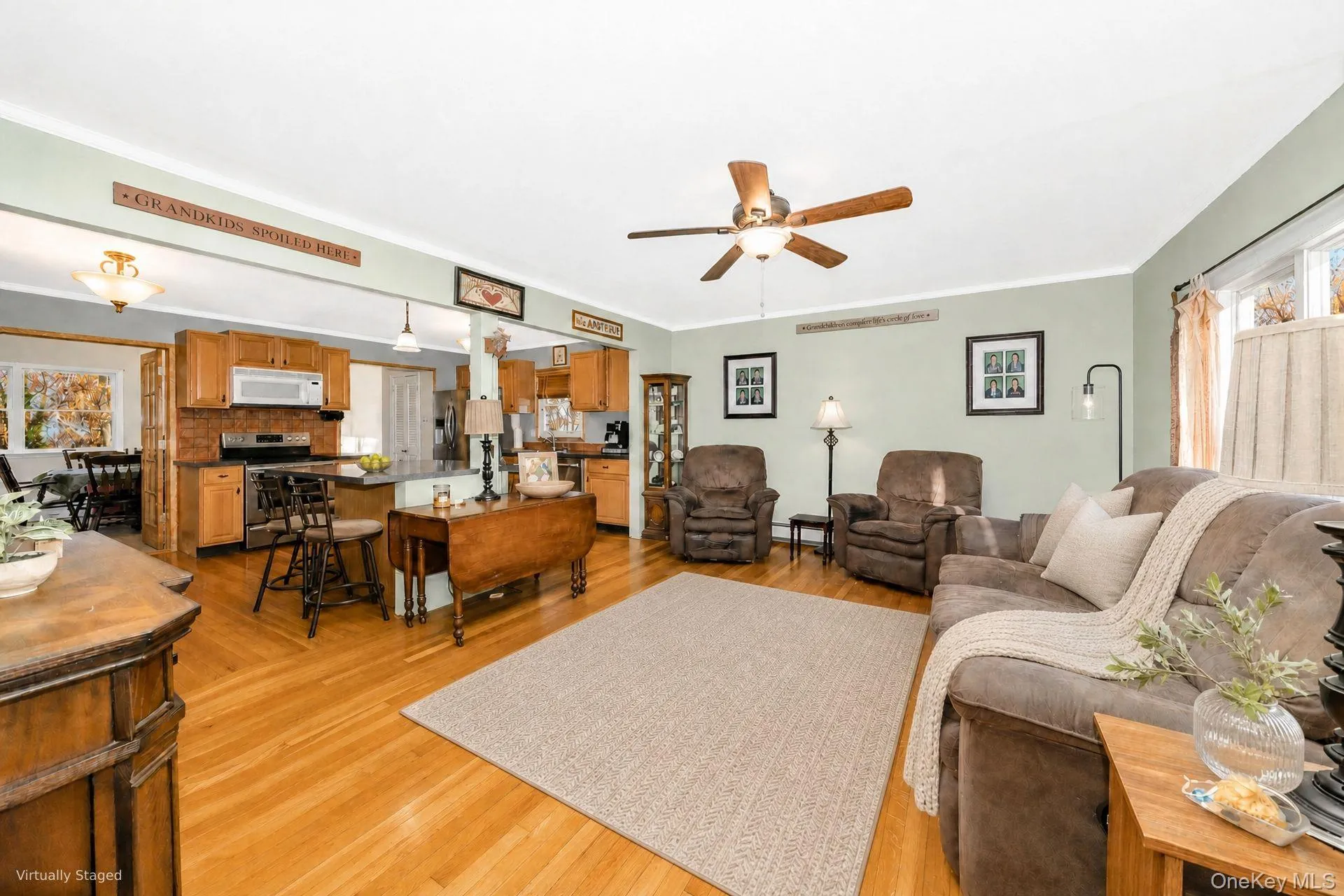 Bright living room with hardwood floors and open flow (staged with virtual decor) Bright living room with hardwood floors and open flow (staged with virtual decor)