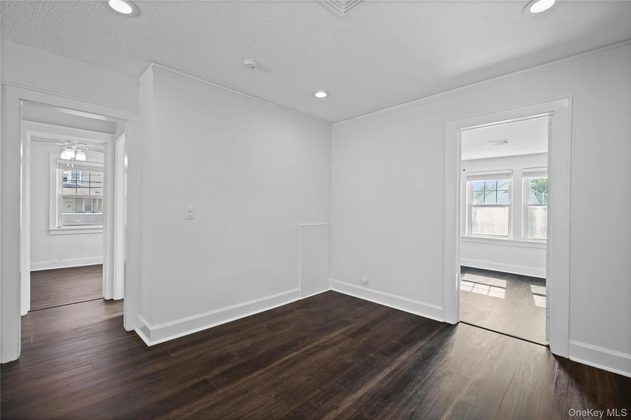 Unfurnished room featuring recessed lighting and dark wood-style flooring Unfurnished room featuring recessed lighting and dark wood-style flooring