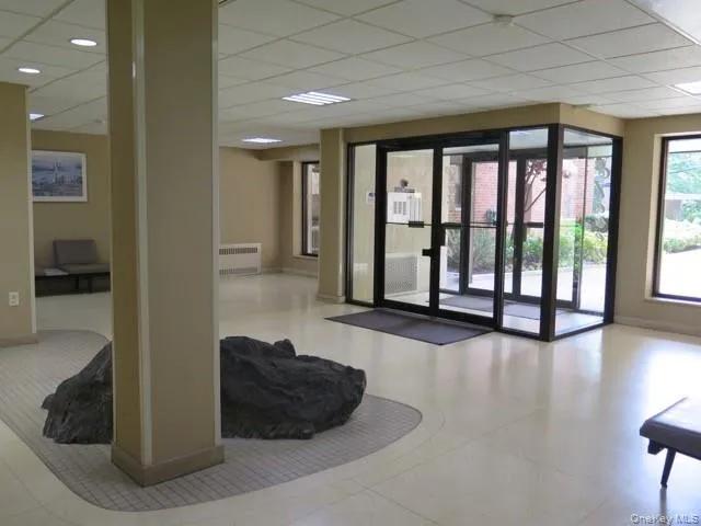 Building lobby featuring a paneled ceiling and recessed lighting Building lobby featuring a paneled ceiling and recessed lighting