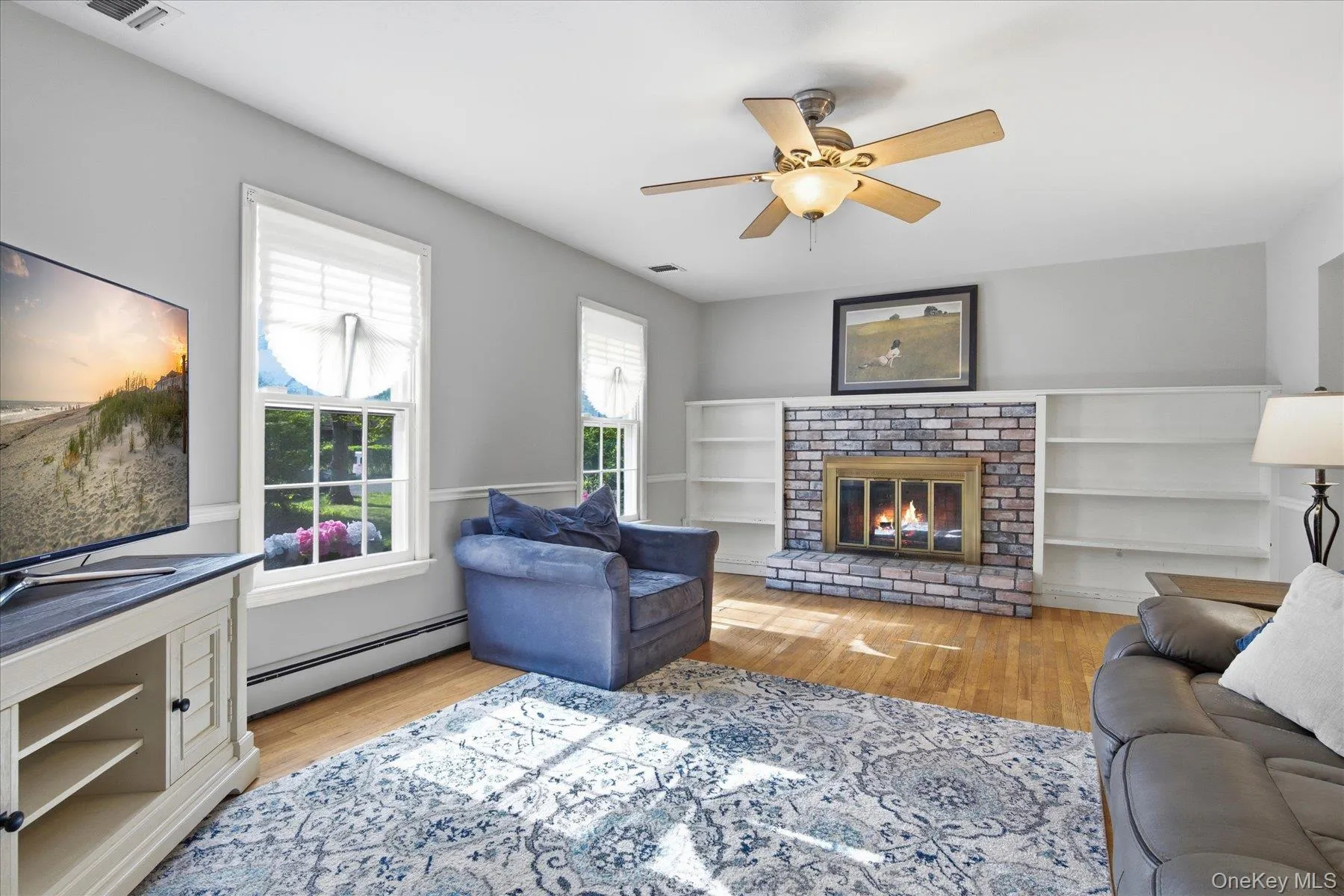 Formal Living Room with Fireplace and built in book case and the warmth of the afternoon sun Formal Living Room with Fireplace and built in book case and the warmth of the afternoon sun