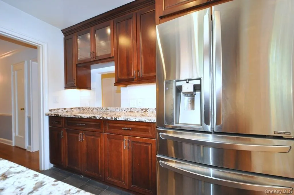 Renovated Kitchen with granite counter, stainless steel appliances and custom cherry cabinets. Renovated Kitchen with granite counter, stainless steel appliances and custom cherry cabinets.
