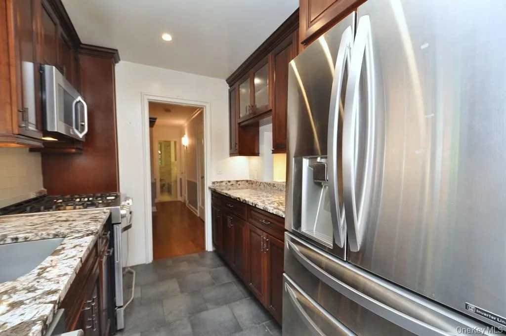 Renovated Kitchen with granite counter, stainless steel appliances and custom cherry cabinets. Renovated Kitchen with granite counter, stainless steel appliances and custom cherry cabinets.