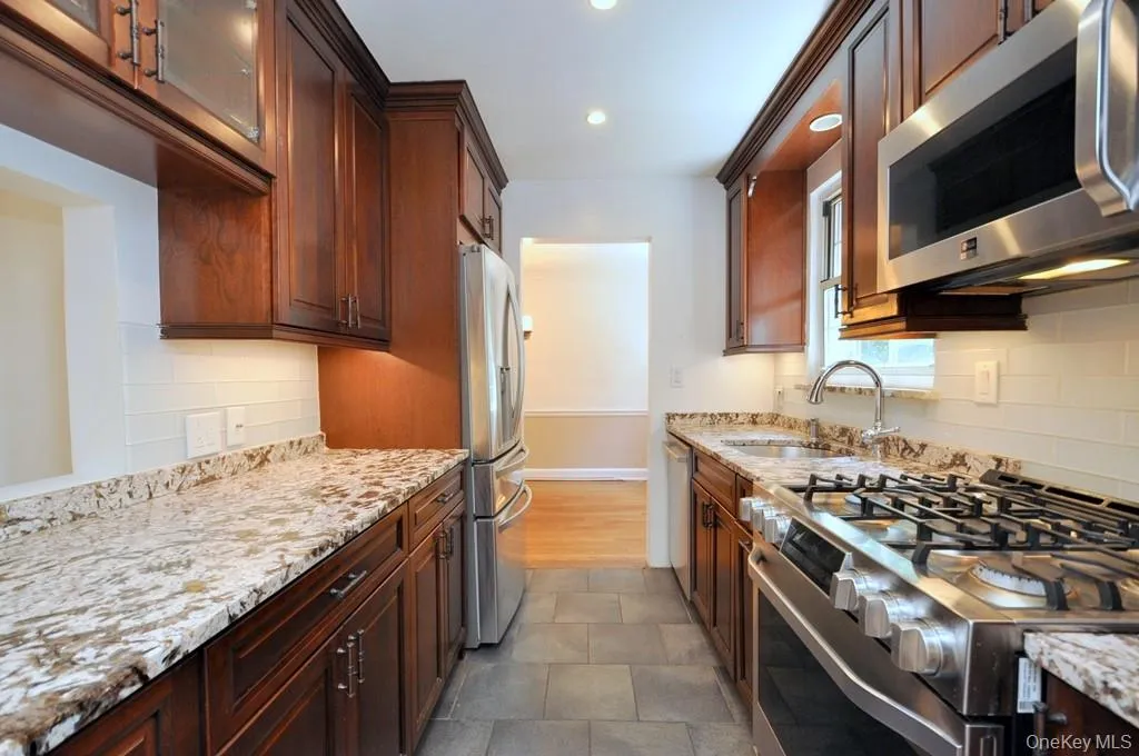 Renovated Kitchen with granite counter, stainless steel appliances and custom cherry cabinets. All up to date custom kitchen appliances and slide out cabinet drawers Renovated Kitchen with granite counter, stainless steel appliances and custom cherry cabinets. All up to date custom kitchen appliances and slide out cabinet drawers