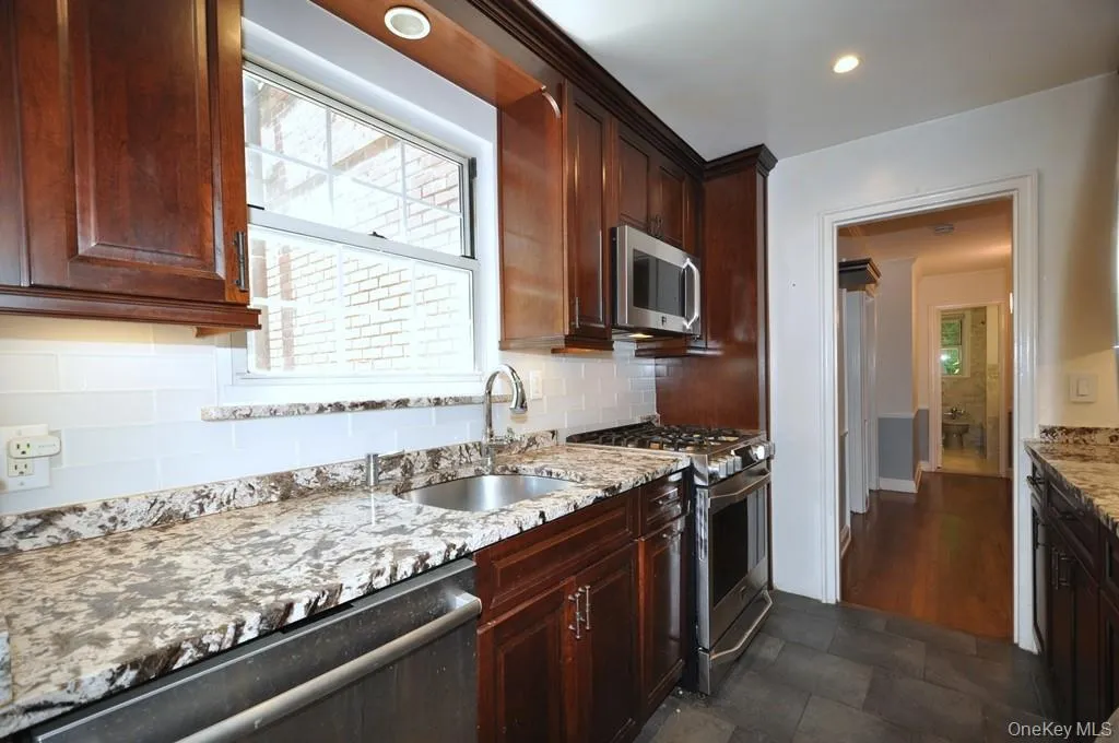 Renovated Kitchen with granite counter, stainless steel appliances and custom cherry cabinets. Renovated Kitchen with granite counter, stainless steel appliances and custom cherry cabinets.