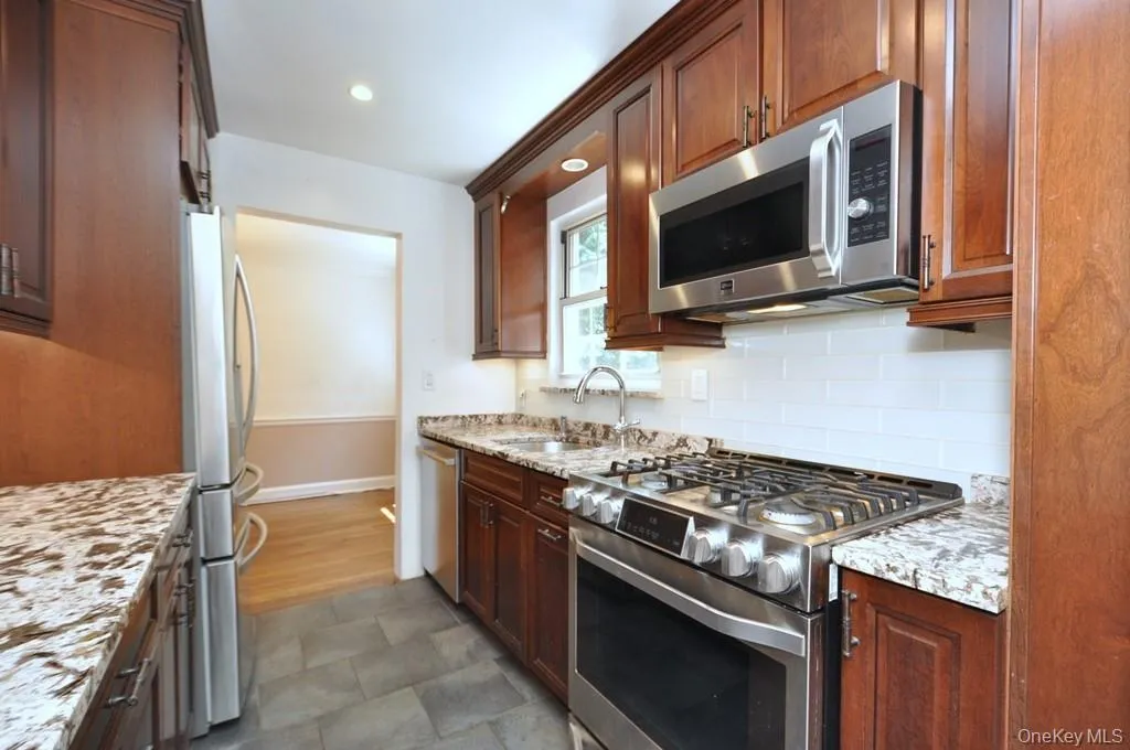 Renovated Kitchen with granite counter, stainless steel appliances and custom cherry cabinets. Renovated Kitchen with granite counter, stainless steel appliances and custom cherry cabinets.