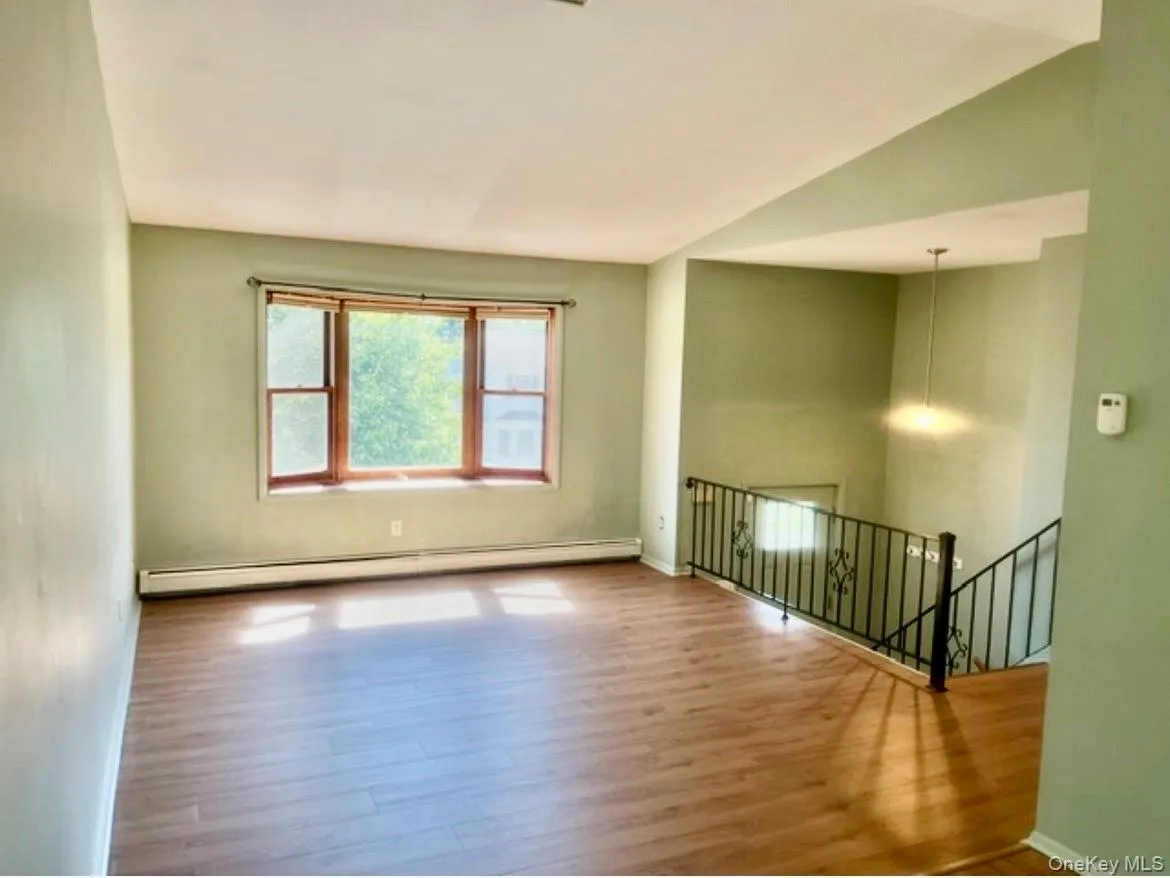 Bright and open living room with Bow window and all new floors Bright and open living room with Bow window and all new floors