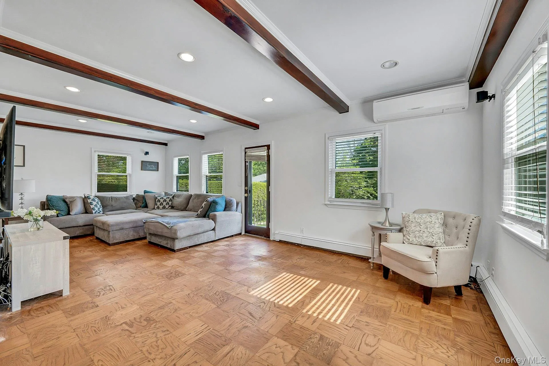 Large family room showing door to yard and split system for heat and air conditioning Large family room showing door to yard and split system for heat and air conditioning