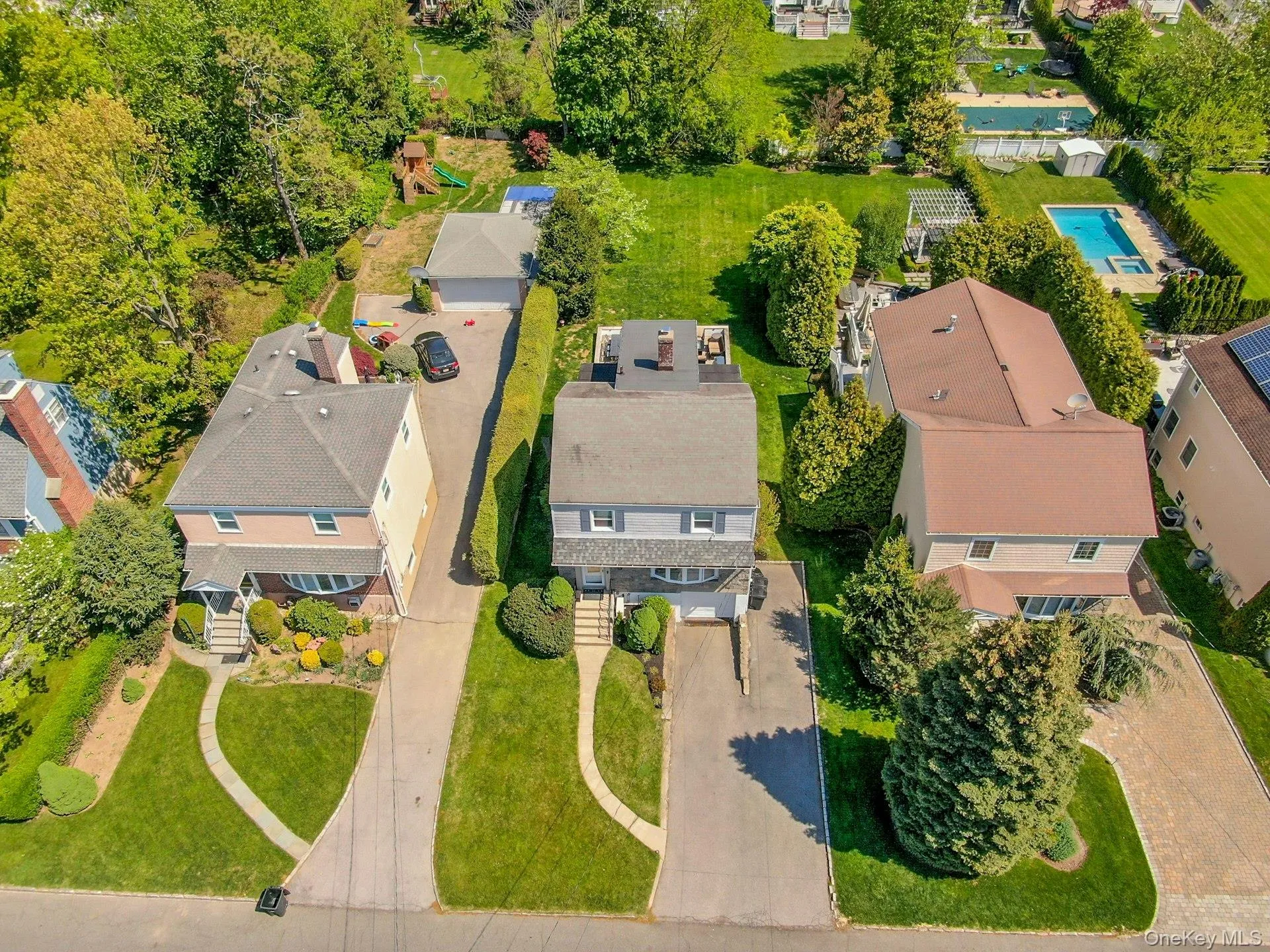 An aerial view of 45 Highland Avenue showing the driveway and large yard An aerial view of 45 Highland Avenue showing the driveway and large yard