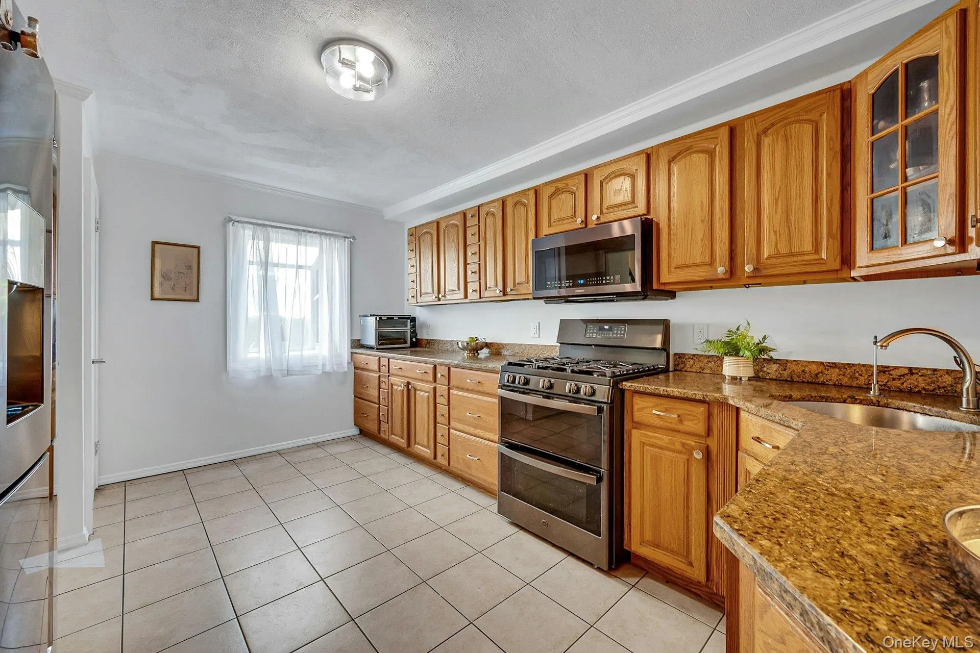 A view of the kitchen showing the granite counters and stainless-steel appliances A view of the kitchen showing the granite counters and stainless-steel appliances