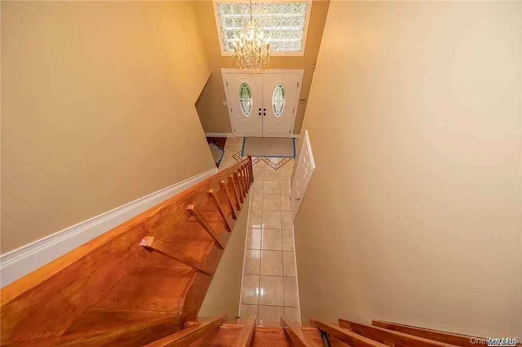 Stairway leading from second floor leading to the front door with grand entrance Stairway leading from second floor leading to the front door with grand entrance