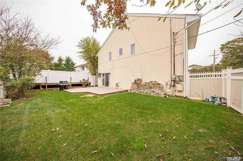 Back of house with big yard- vinyl fencing and patio area Back of house with big yard- vinyl fencing and patio area