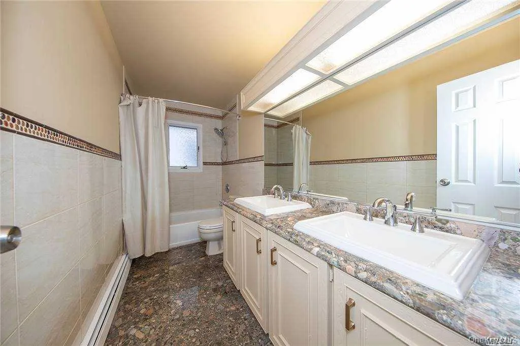 One of 2 full bathrooms-updated with double sinks and tub. One of 2 full bathrooms-updated with double sinks and tub.