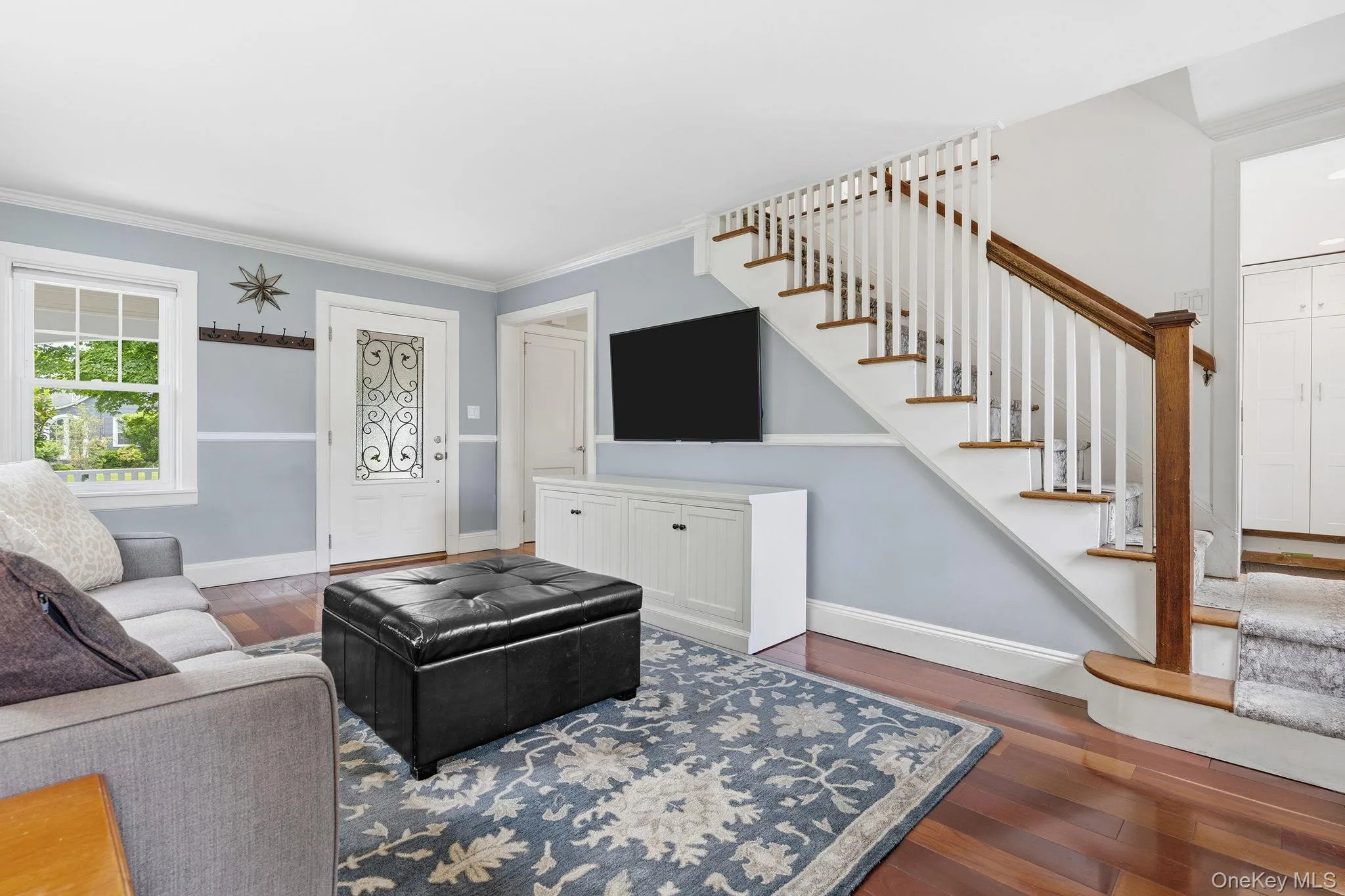 Filled with natural light, this welcoming living room offers the perfect setting for relaxing or entertaining. Filled with natural light, this welcoming living room offers the perfect setting for relaxing or entertaining.