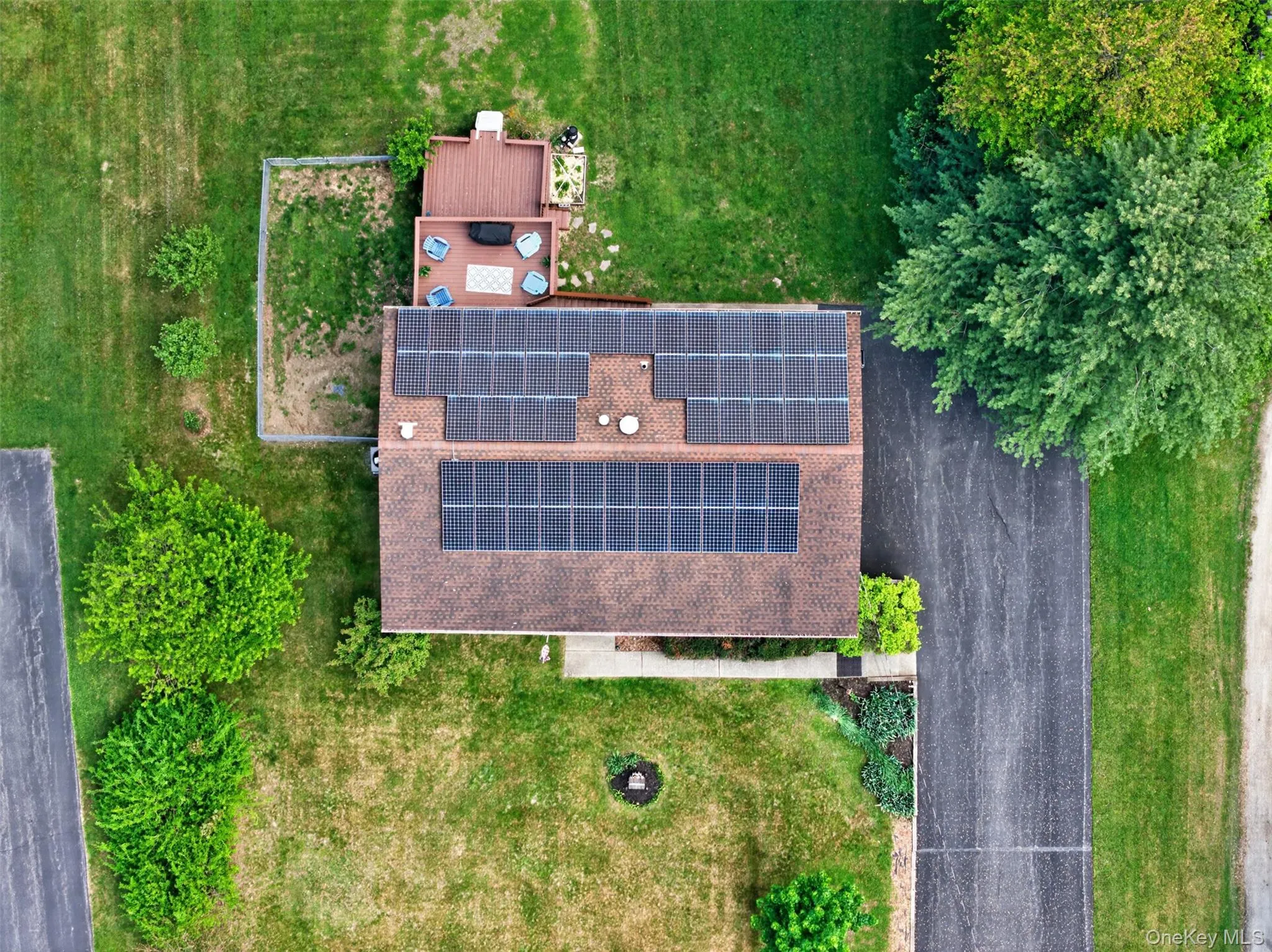 Roofline featuring extensive solar panel installation Roofline featuring extensive solar panel installation
