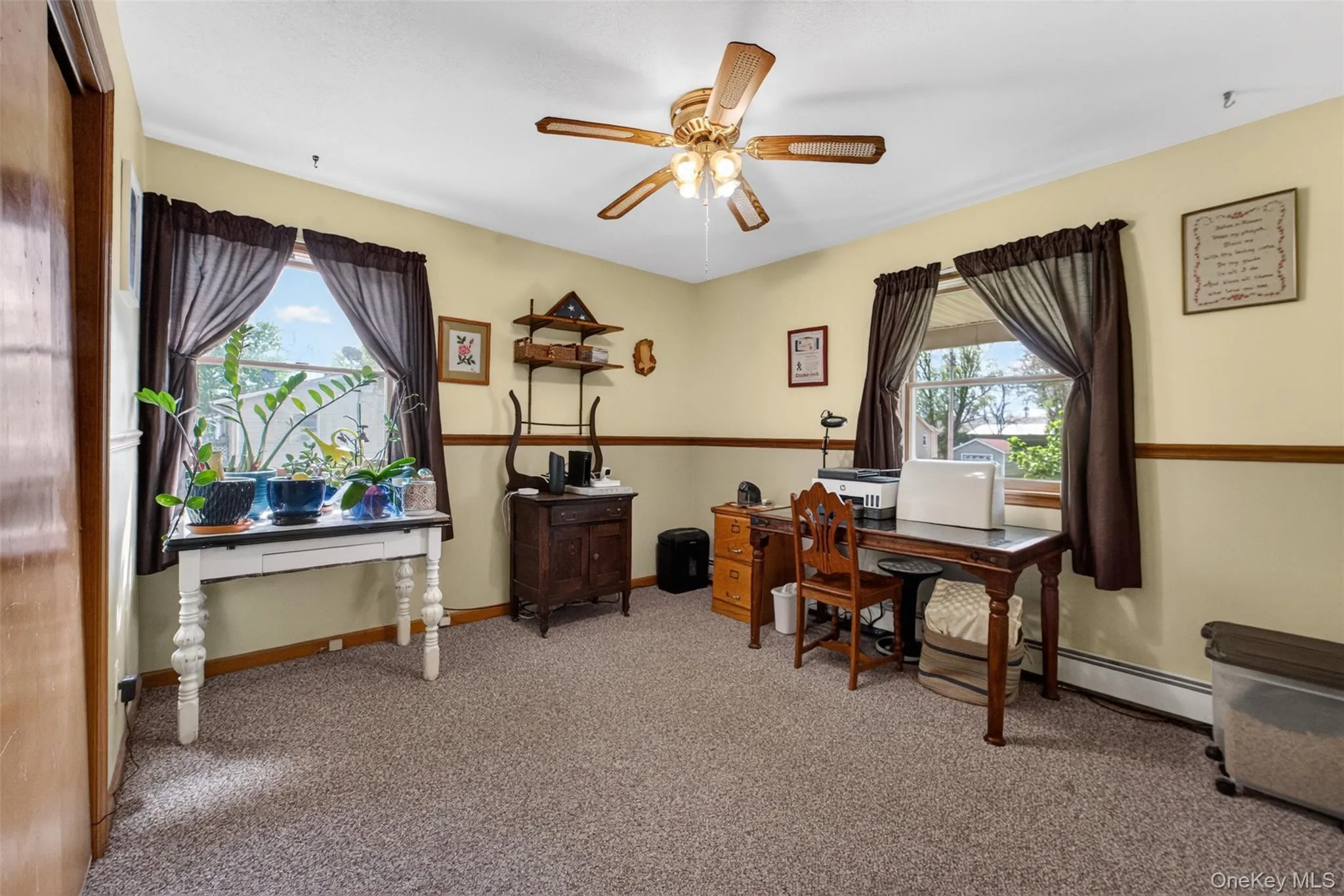 Carpeted room featuring dual windows, a ceiling fan with integrated lighting. Carpeted room featuring dual windows, a ceiling fan with integrated lighting.