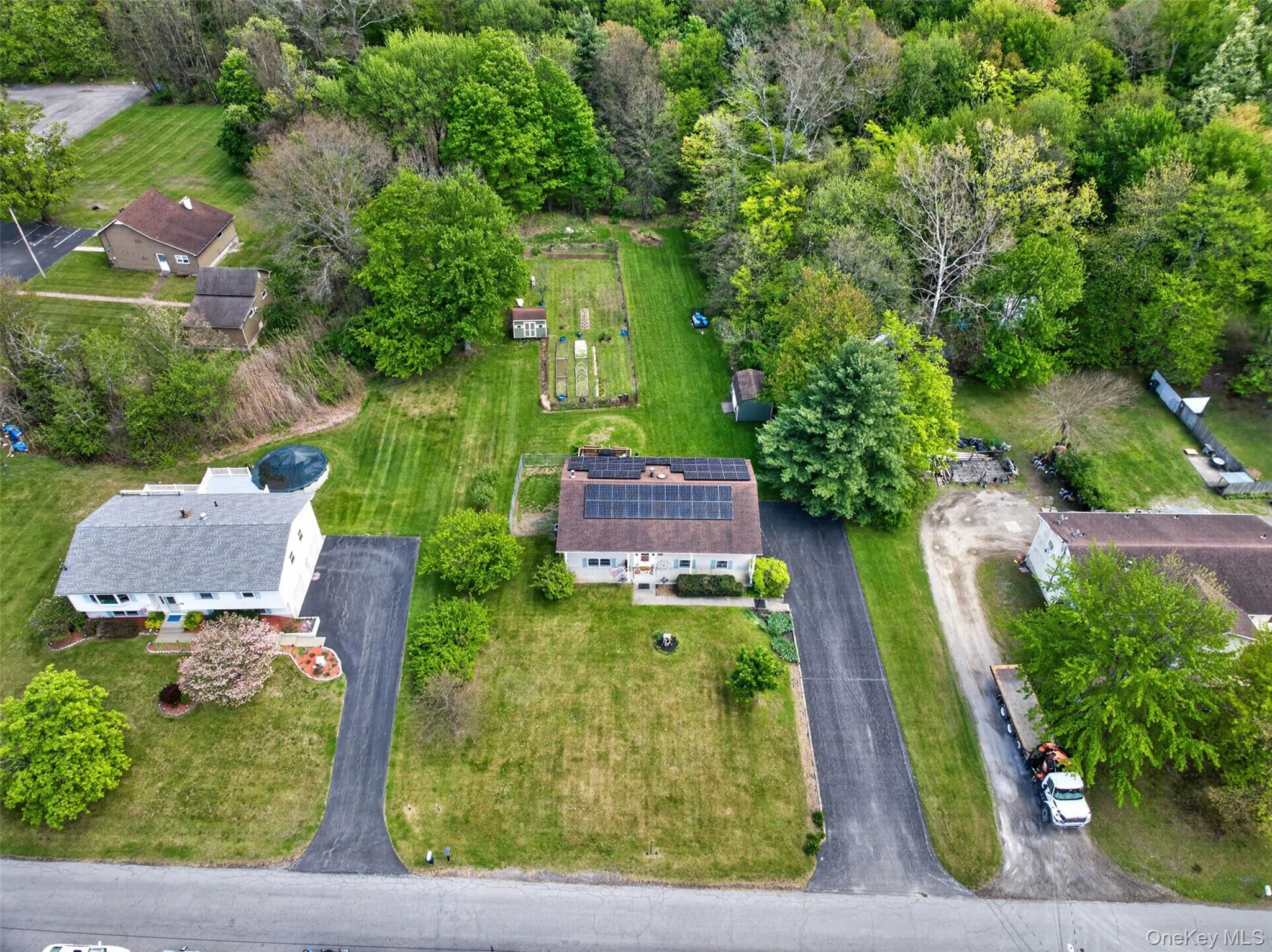 Aerial perspective showcasing a property with extensive grounds Aerial perspective showcasing a property with extensive grounds