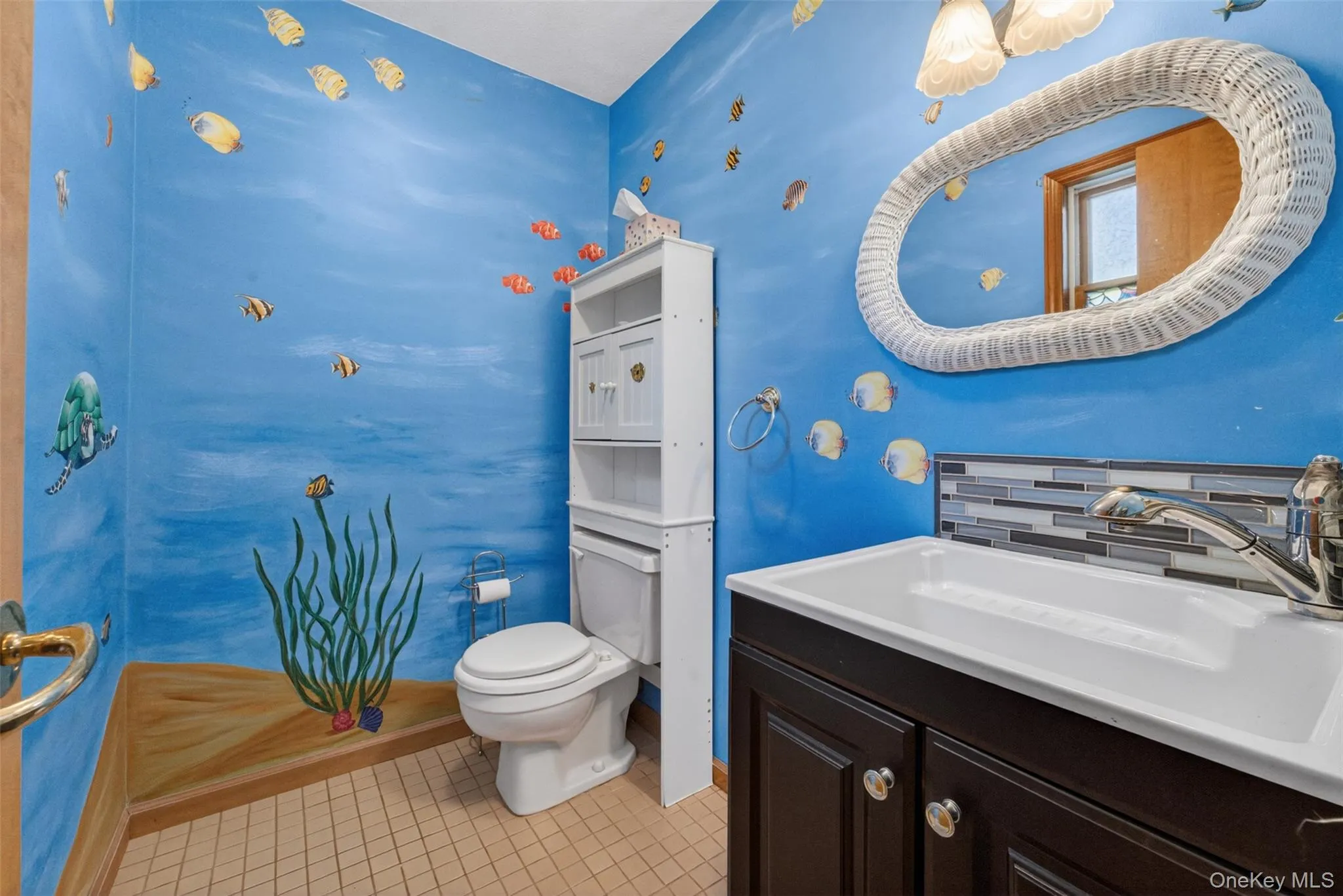 Bathroom featuring a white vanity with a rectangular slop sink, a contemporary chrome faucet, and a mosaic tile backsplash Bathroom featuring a white vanity with a rectangular slop sink, a contemporary chrome faucet, and a mosaic tile backsplash