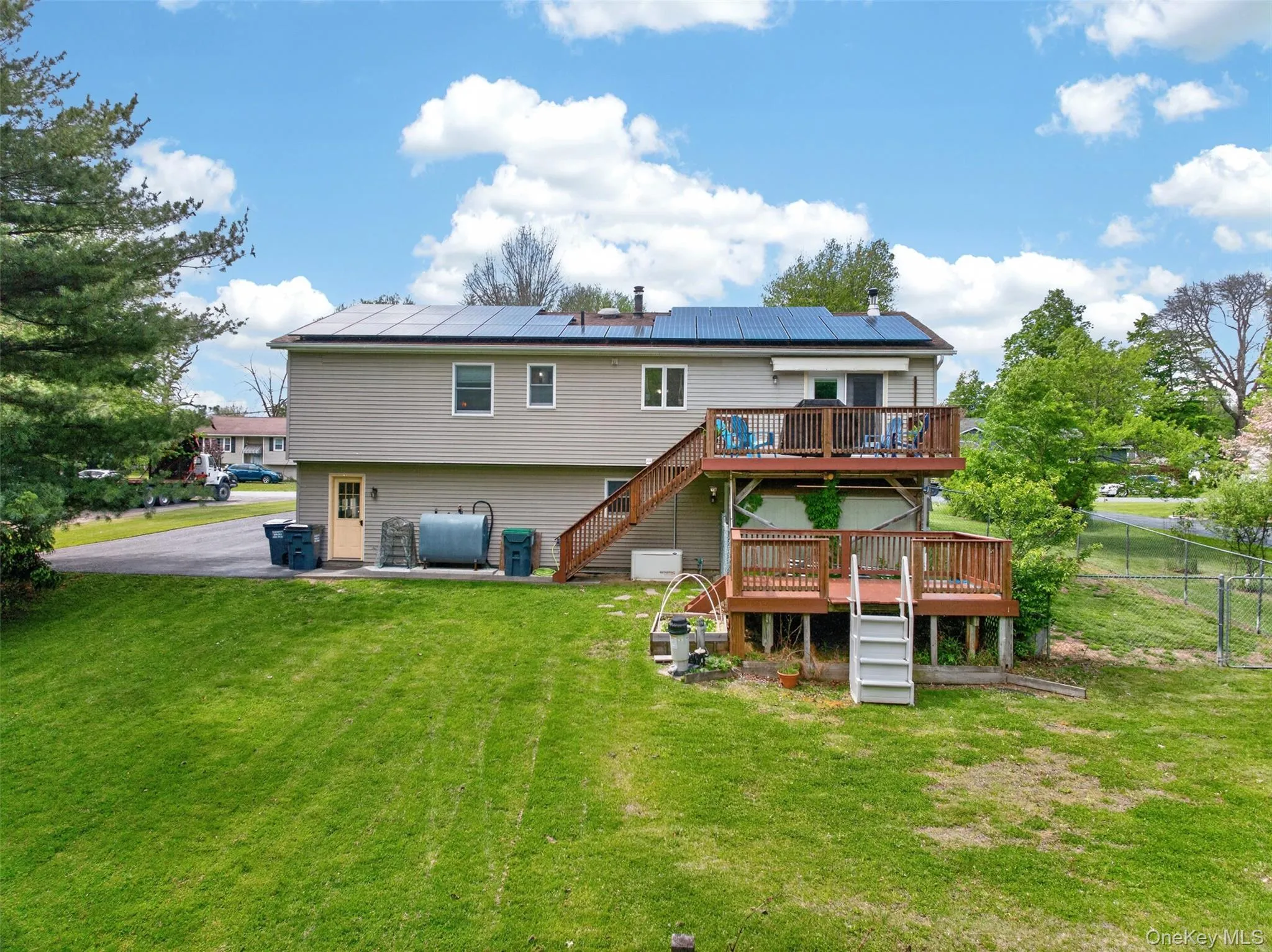 Two-story residence featuring vinyl siding, multiple solar panels, and 2 story deck. Secured Fenced in Dog Run. Two-story residence featuring vinyl siding, multiple solar panels, and 2 story deck. Secured Fenced in Dog Run.
