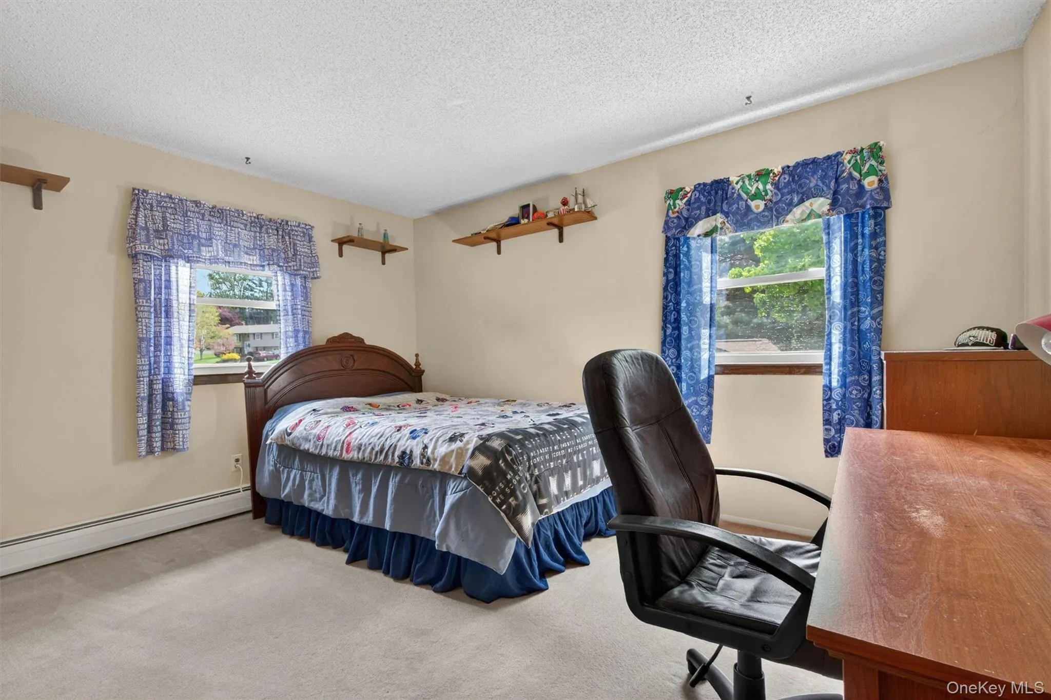 The second bedroom features two windows and enough space for a work area as well as. The second bedroom features two windows and enough space for a work area as well as.