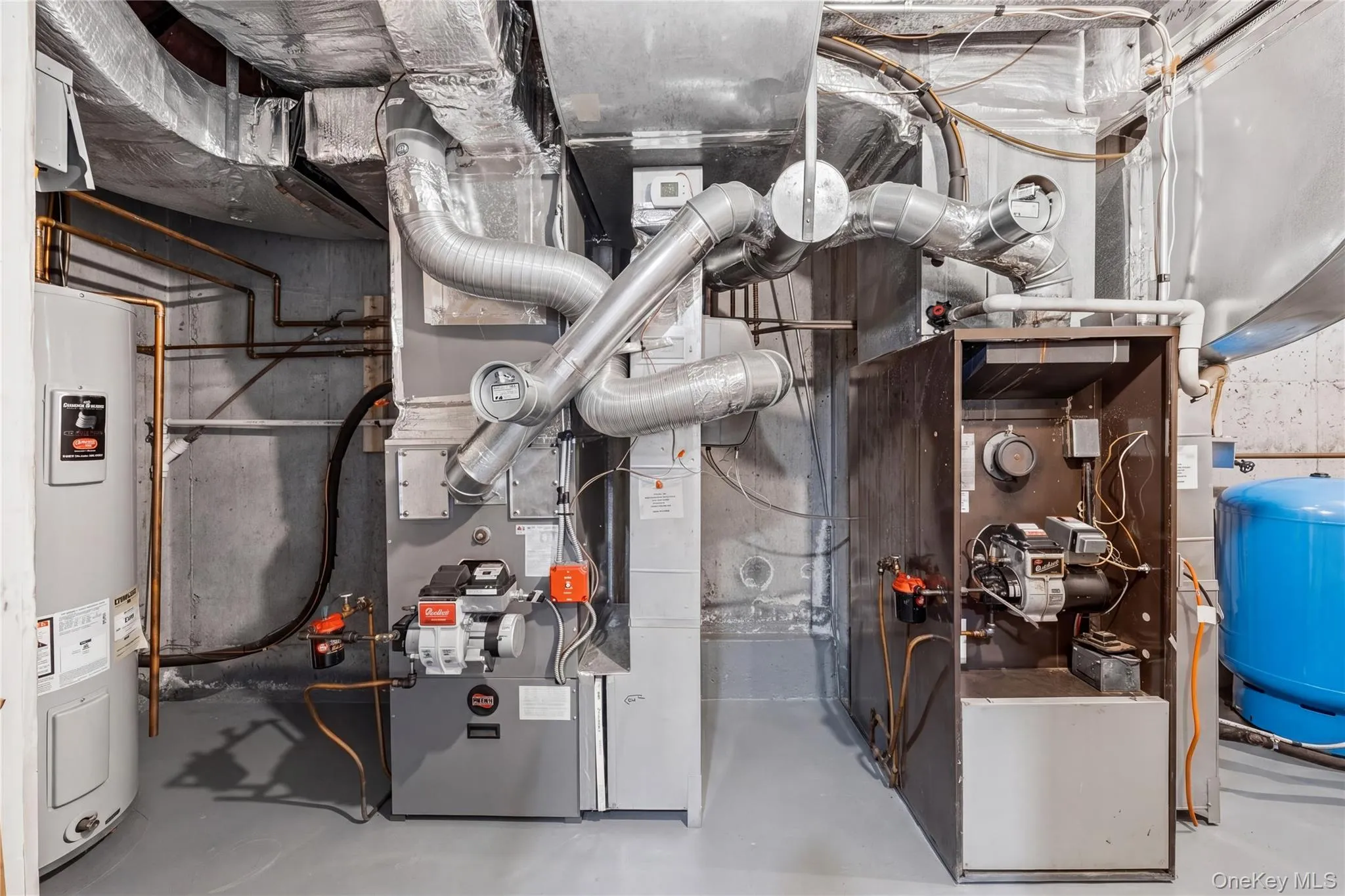 Dedicated mechanical room with two furnaces, a water heater, and an expansion tank Dedicated mechanical room with two furnaces, a water heater, and an expansion tank
