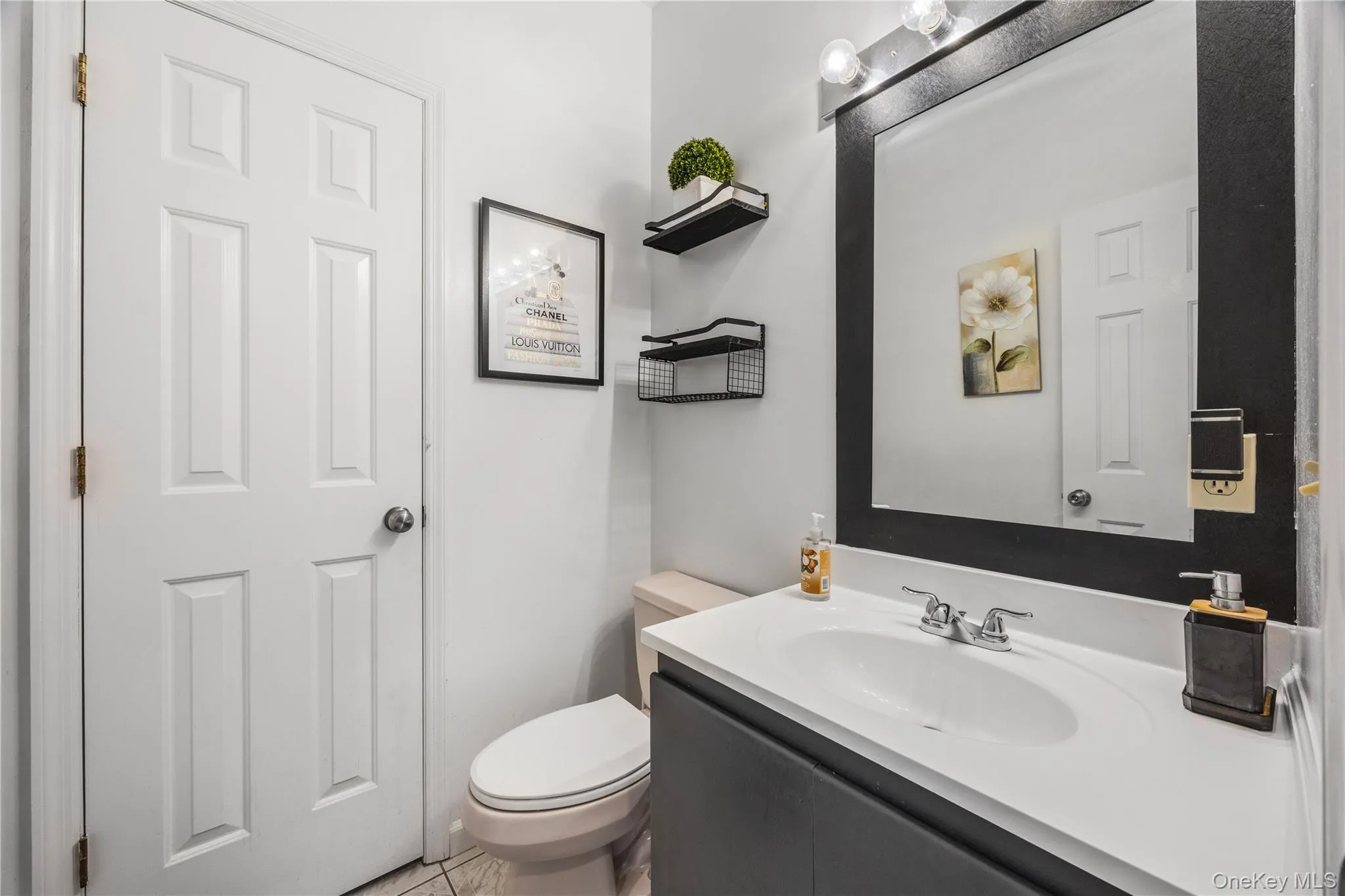 White vanity with an integrated sink and chrome faucet White vanity with an integrated sink and chrome faucet